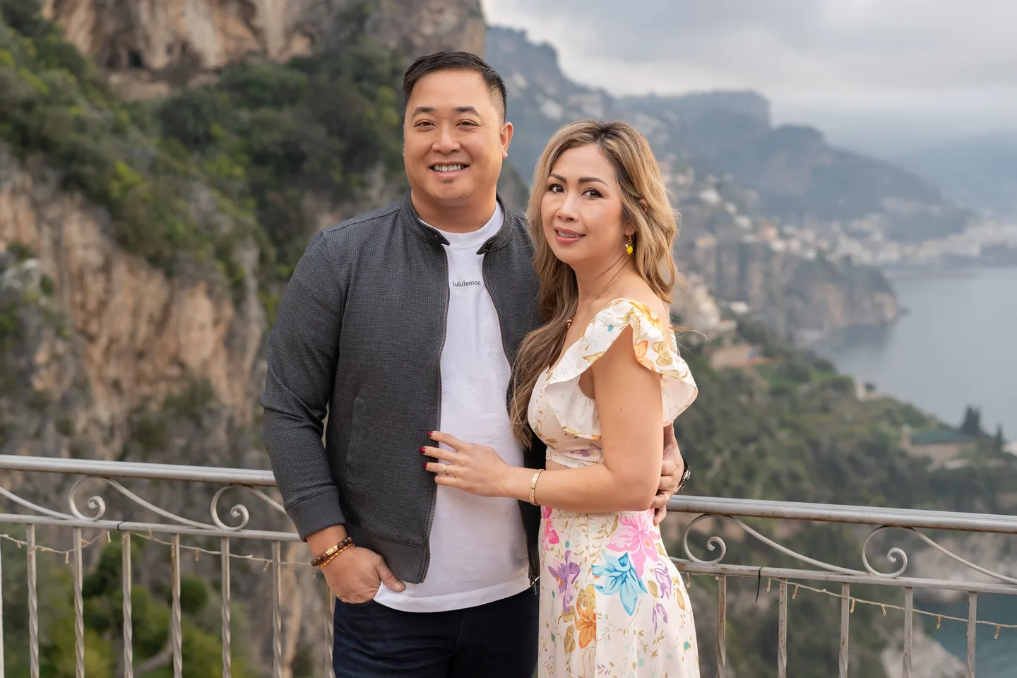 Anh and her companion smiling on the villa balcony