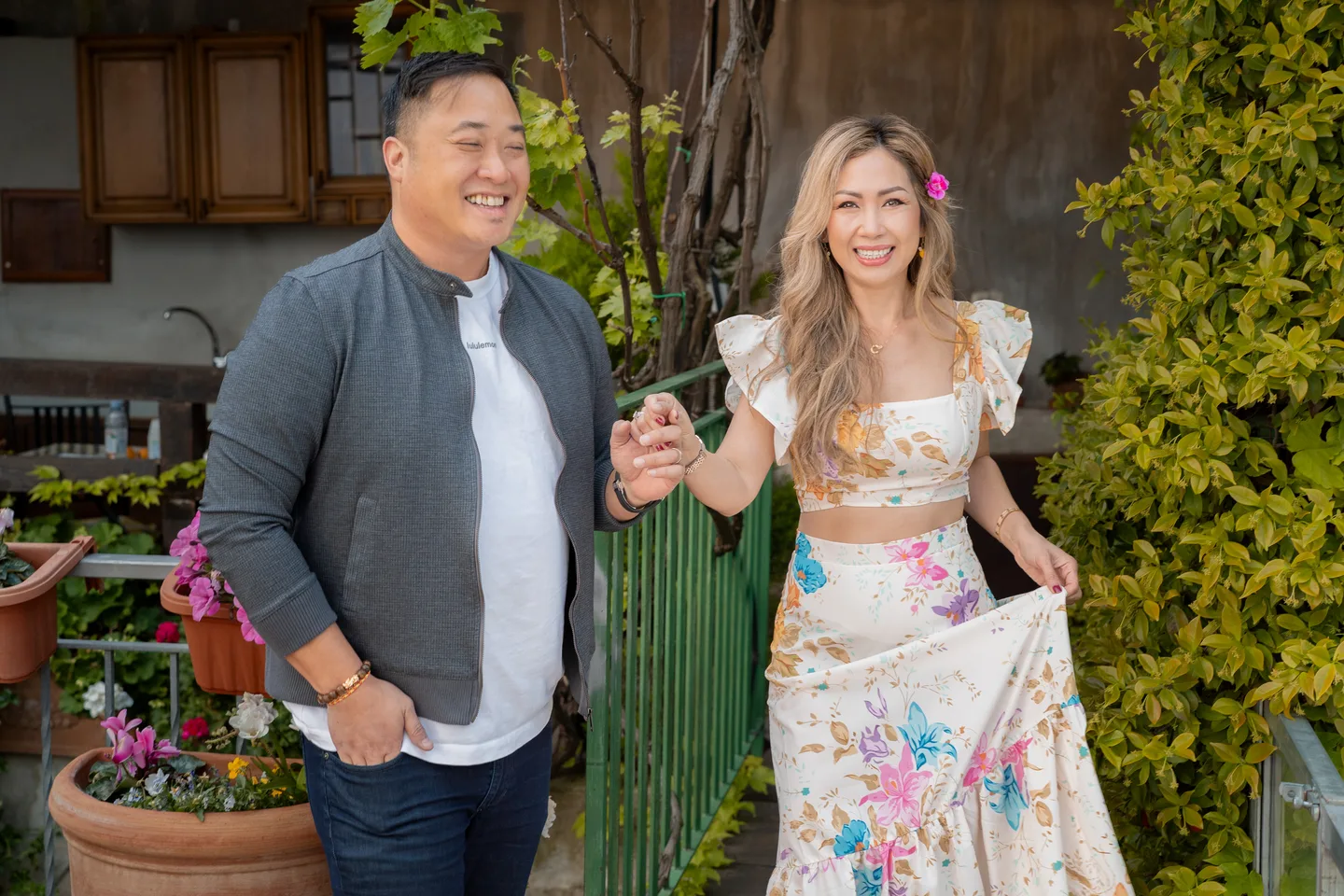 Anh and her companion laughing together outside the villa