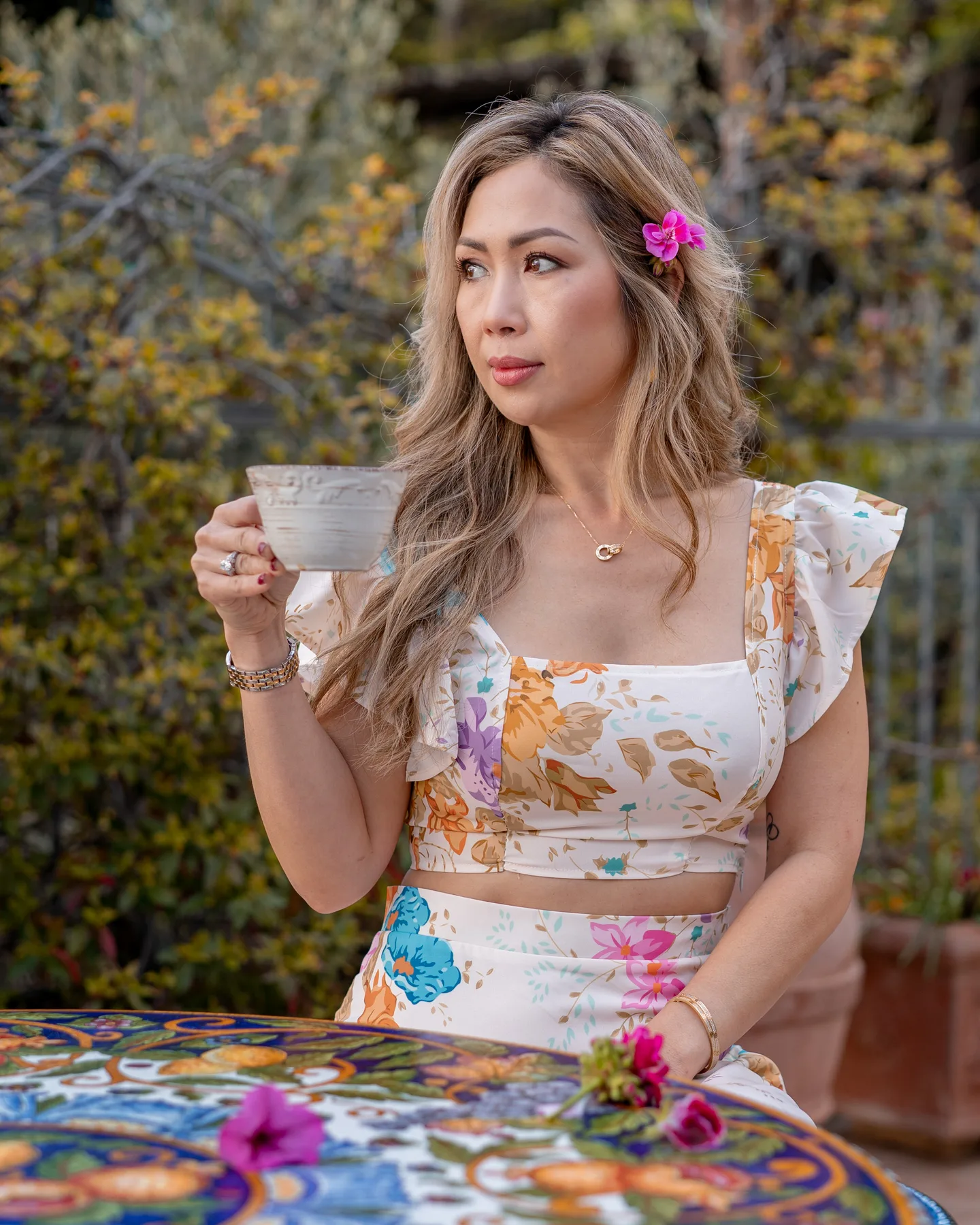 Anh lifting her coffee cup on the terrace