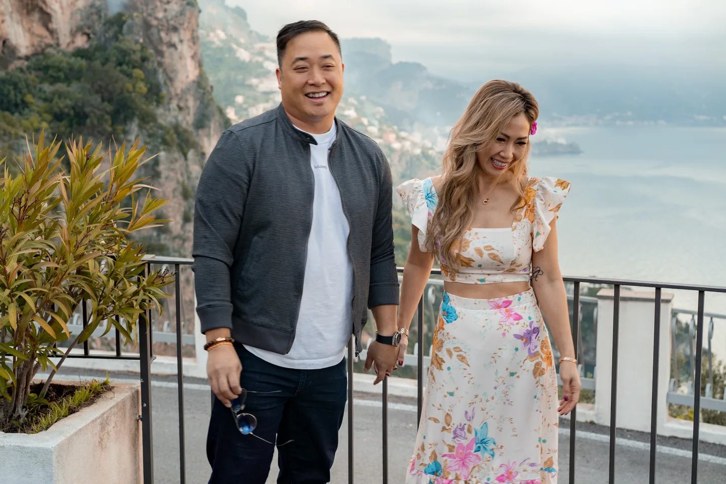 The couple laughing at the coastal viewpoint