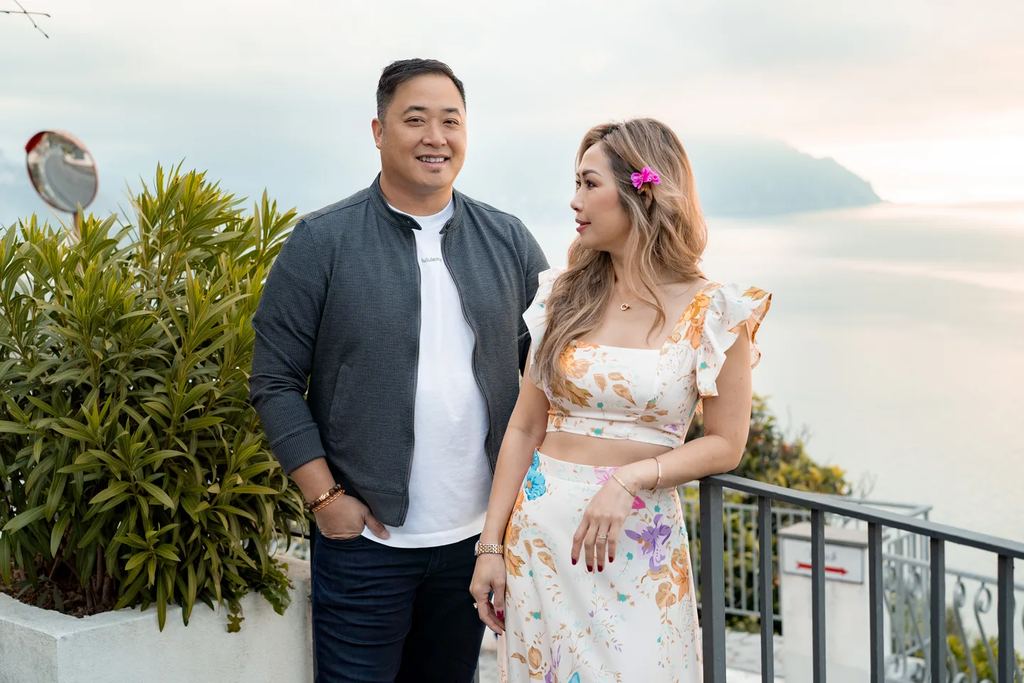 A portrait of the couple with the sea behind them