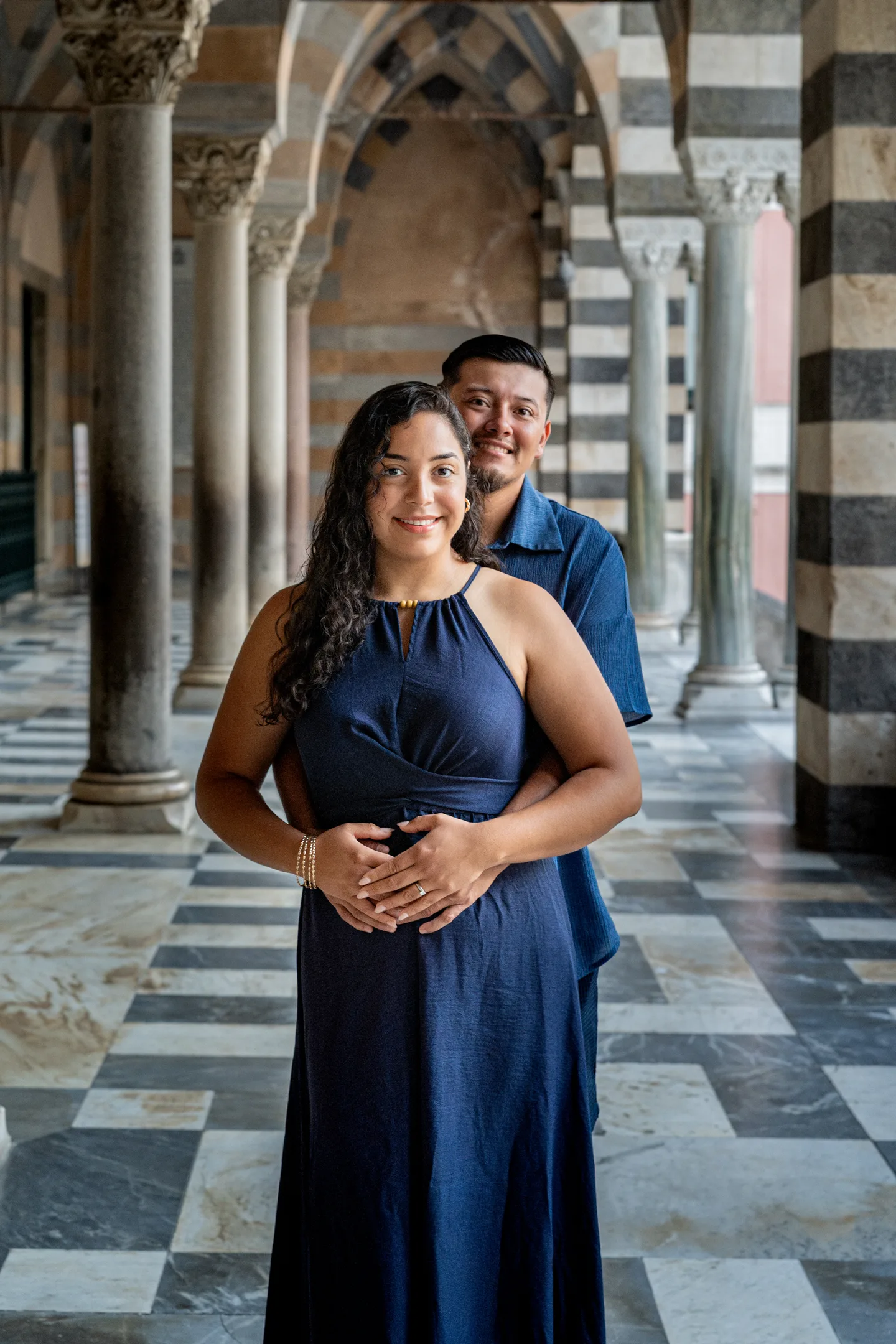 A portrait of the couple beneath the cathedral arches