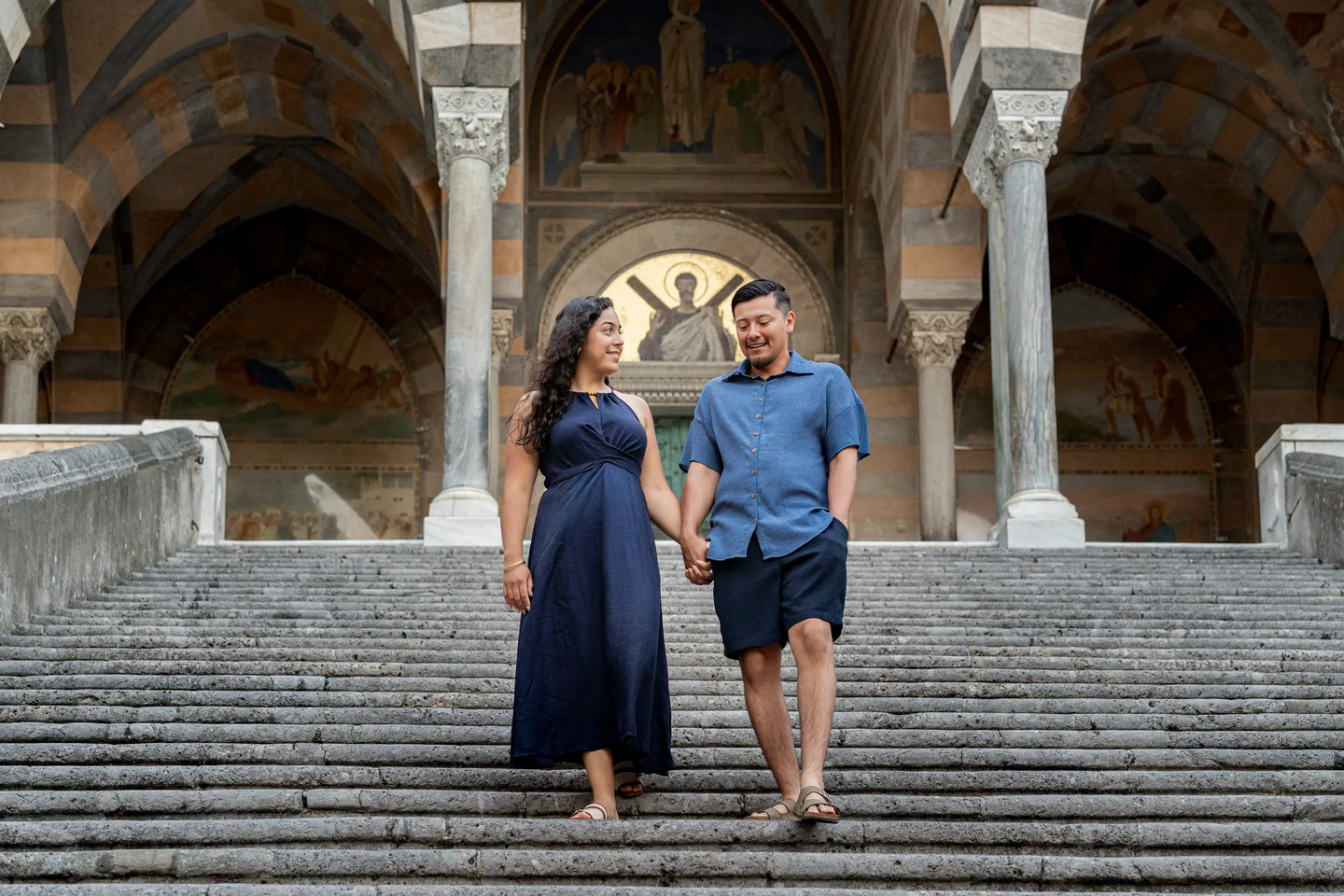The couple walking down the cathedral steps together