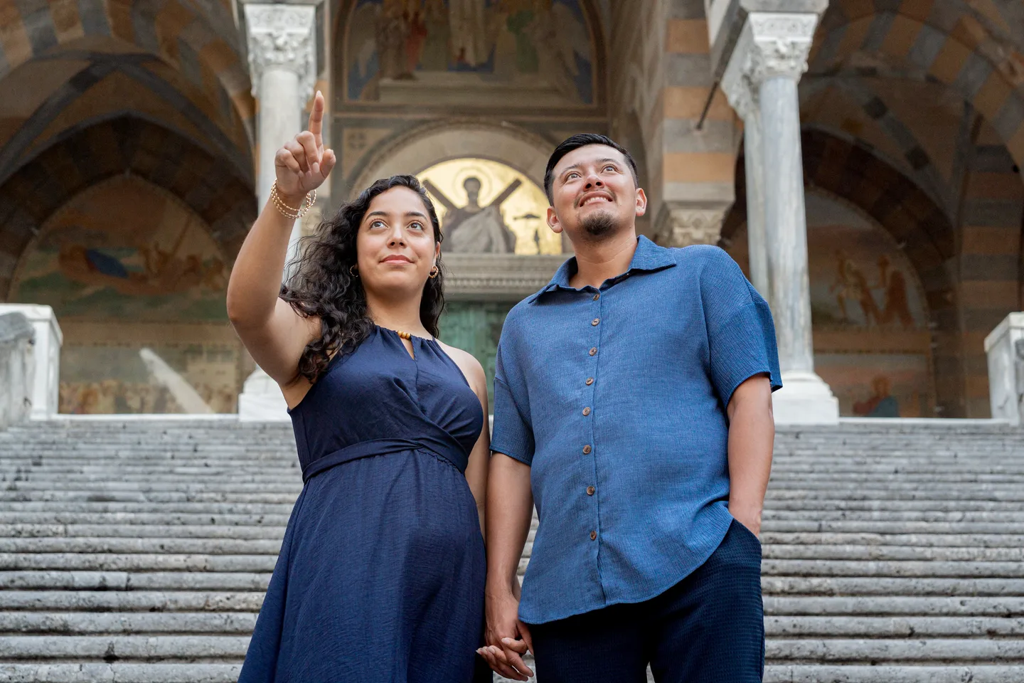 Esmeralda pointing towards the cathedral as her companion looks up