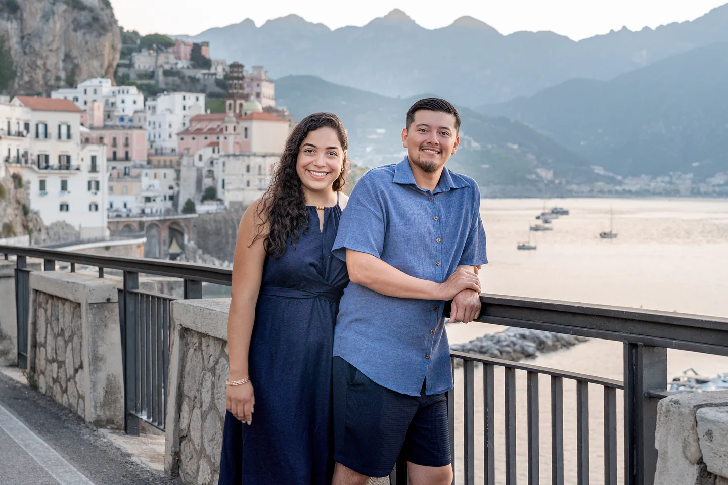 A portrait of the couple with Atrani and the mountains behind them