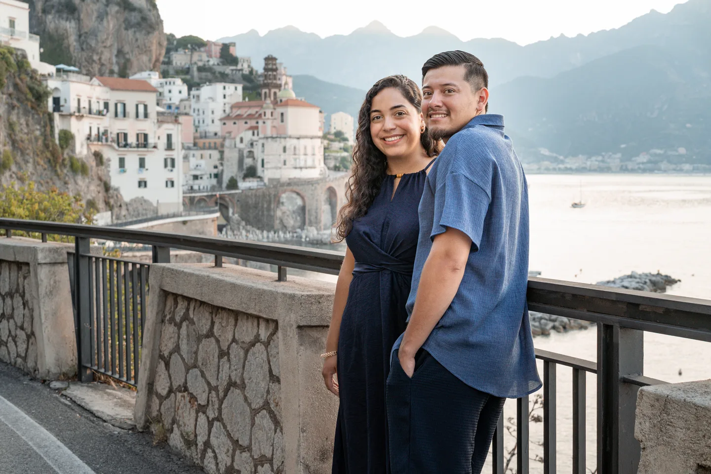 An embrace beside the railing overlooking Atrani