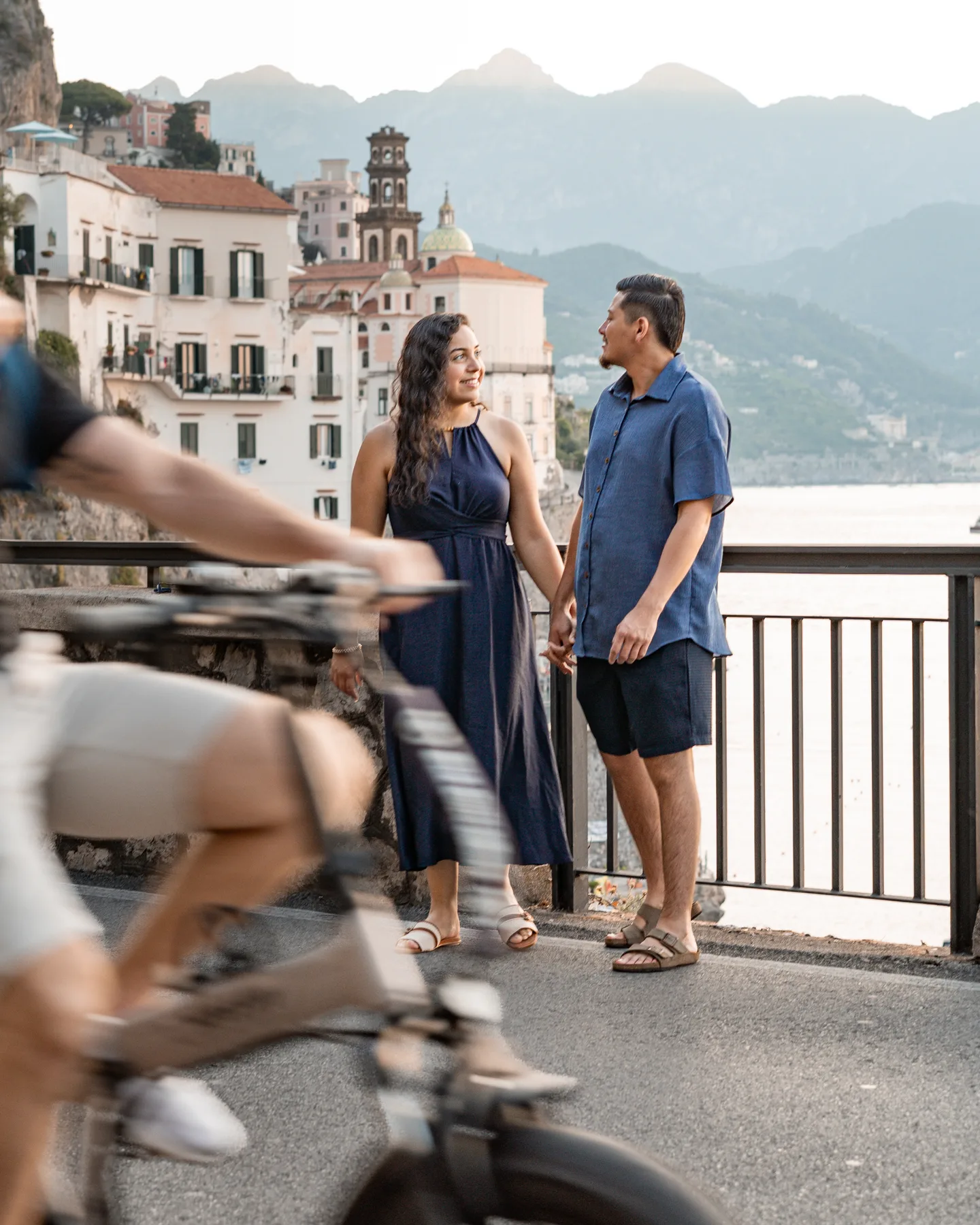 A passing scooter in front of the couple above Atrani