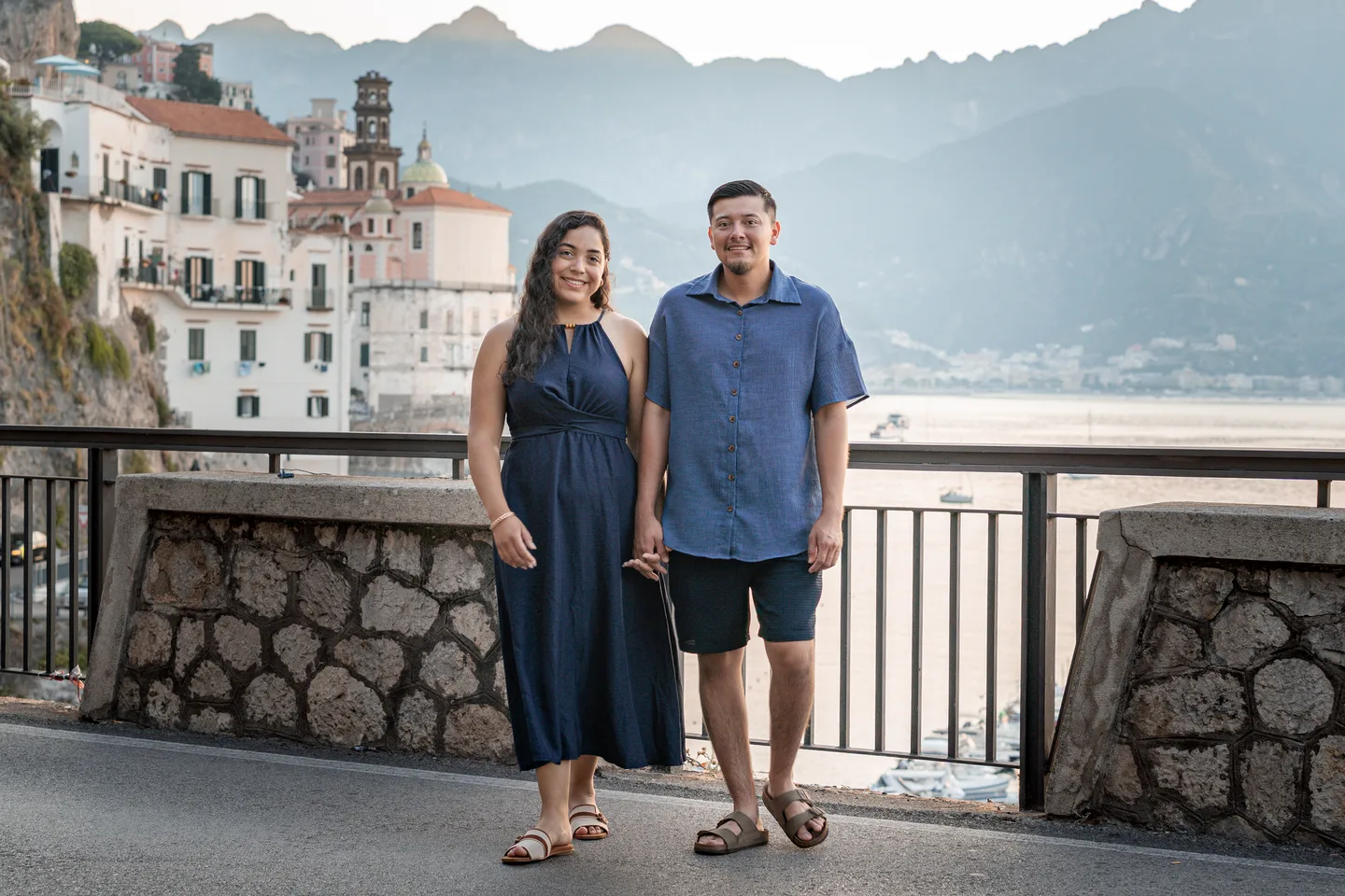 The couple standing together at the coastal overlook