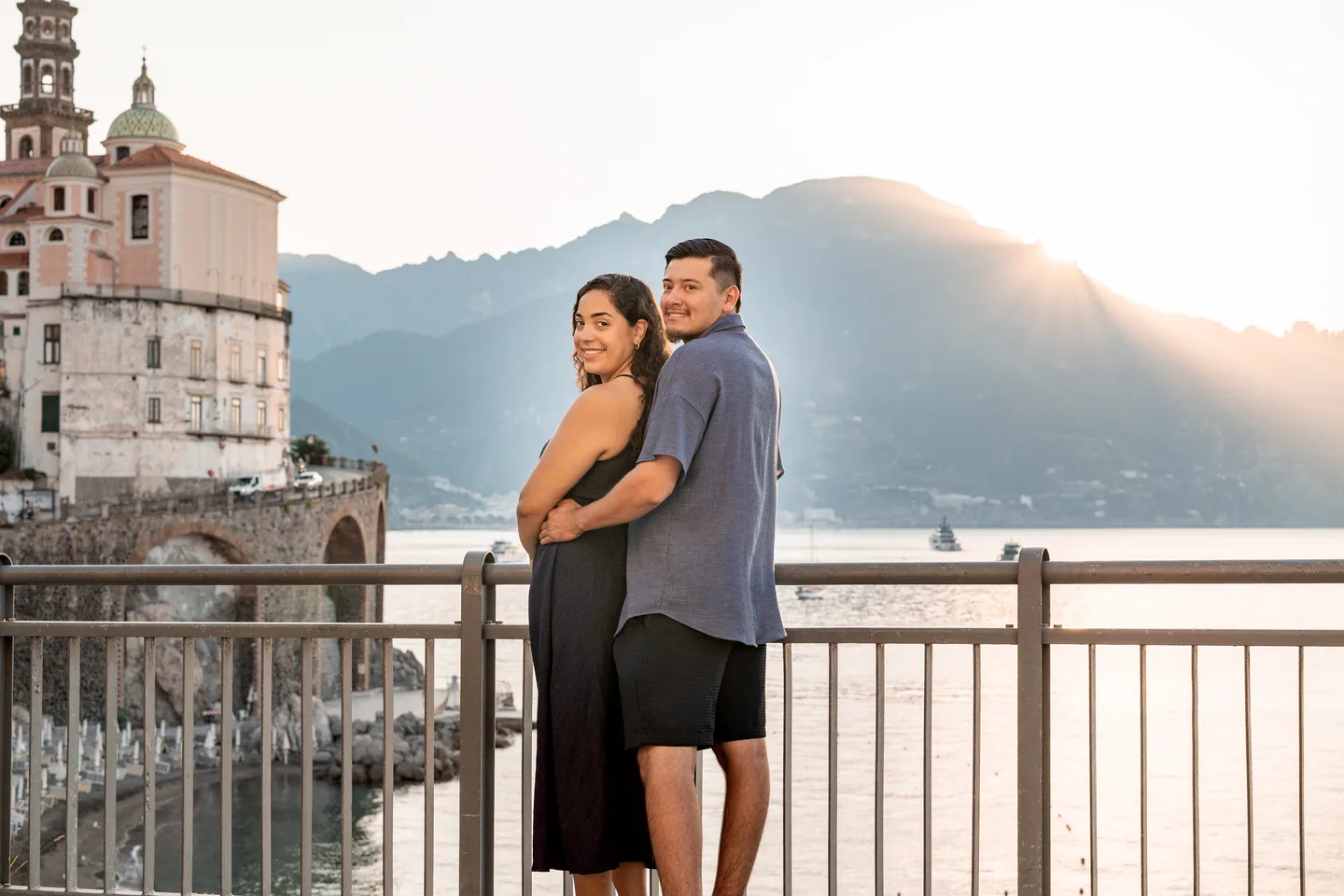 The couple turning towards the camera beside Atrani’s church