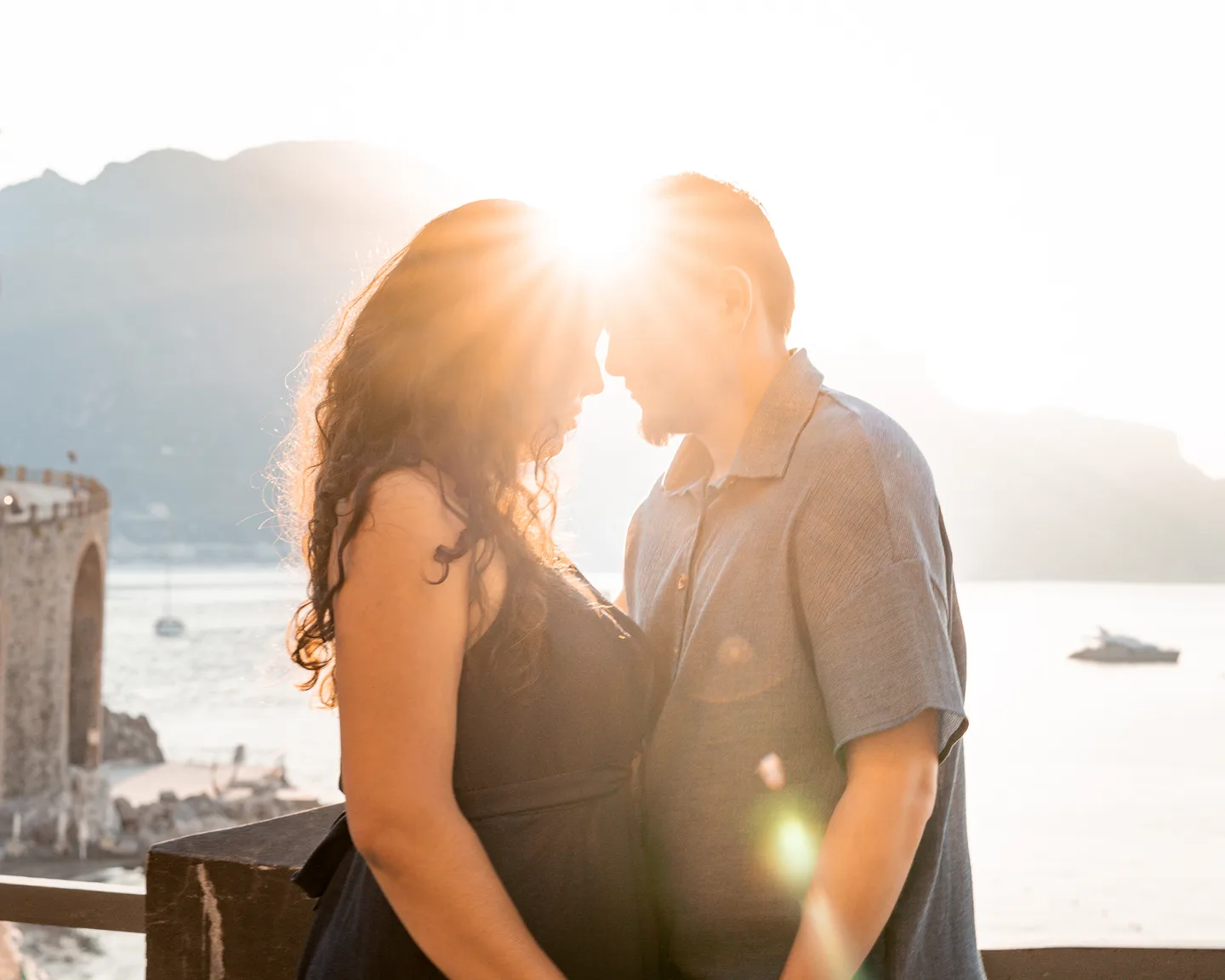 A close kiss with the first sunlight between their faces