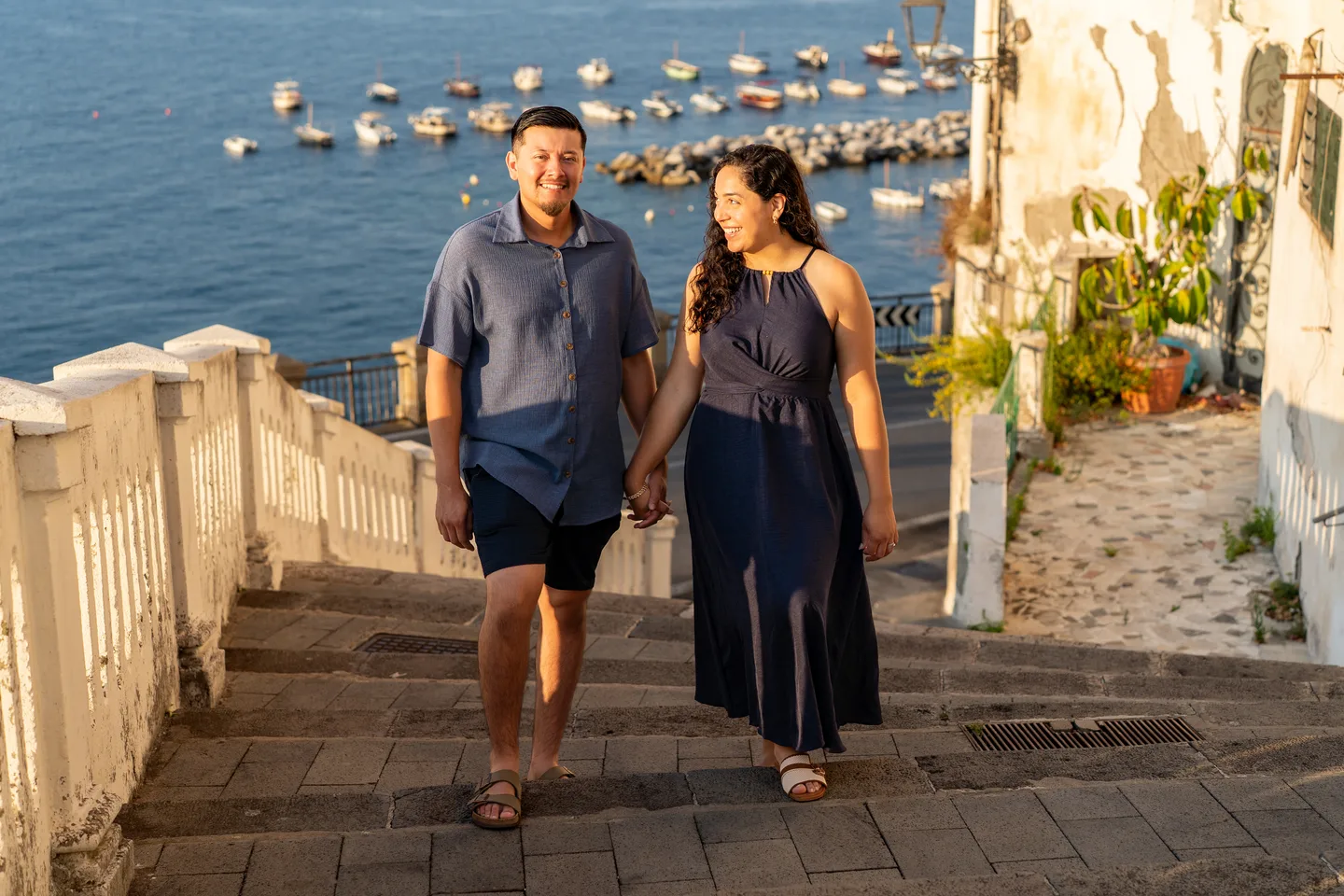 The couple climbing the seaside steps hand in hand
