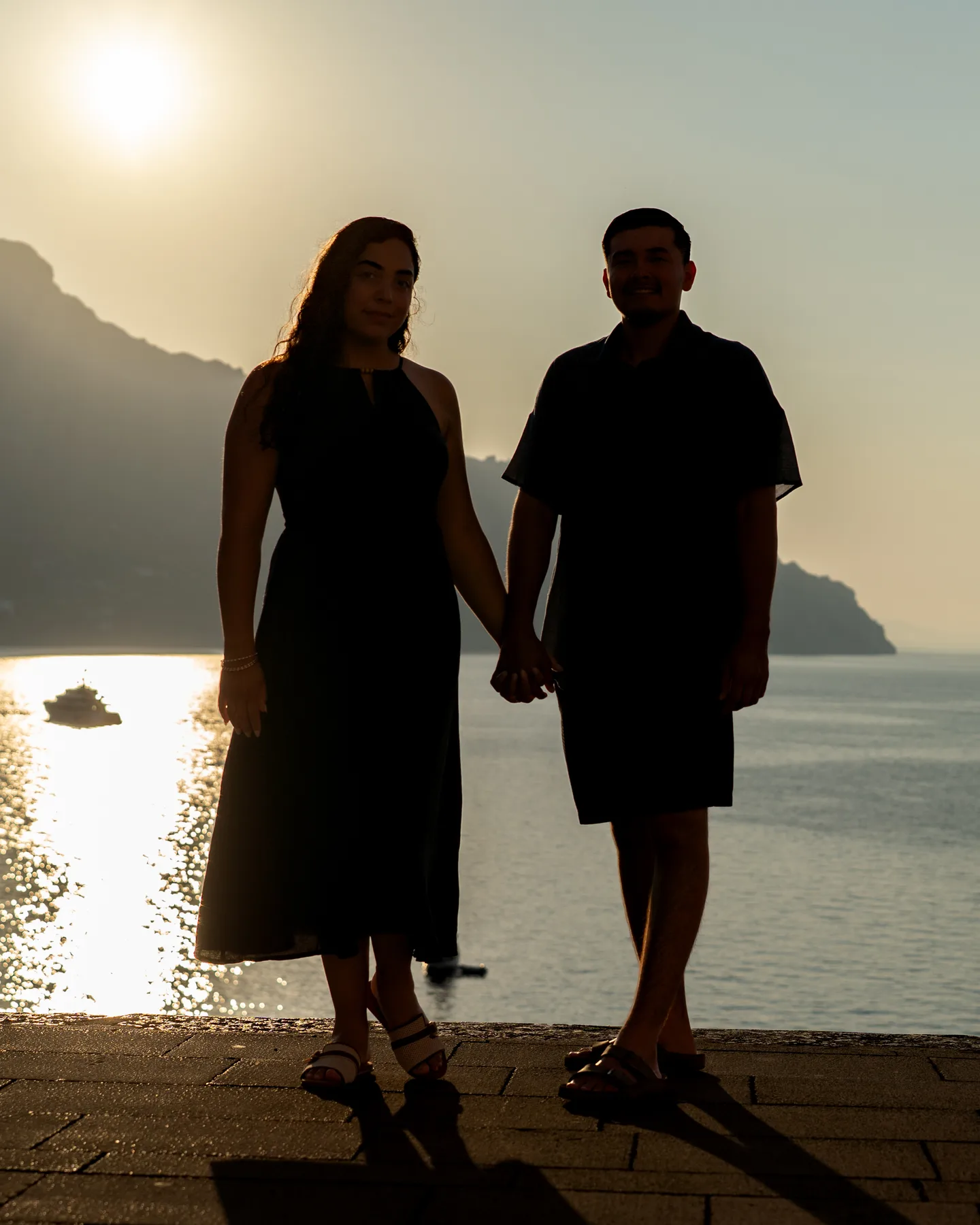 The couple walking hand in hand in silhouette