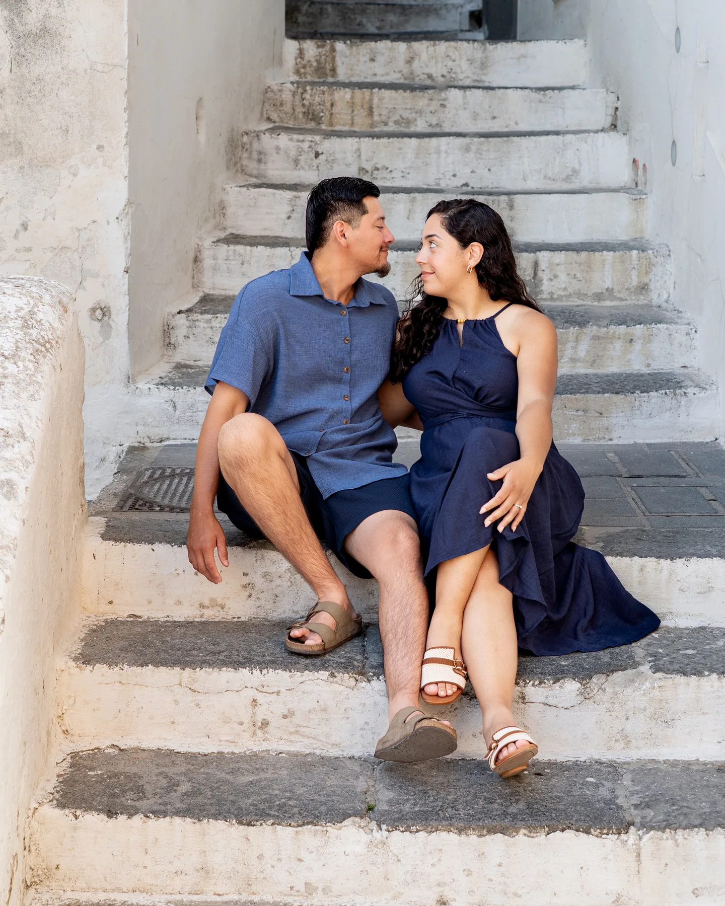 Esmeralda and her companion smiling at each other on the steps