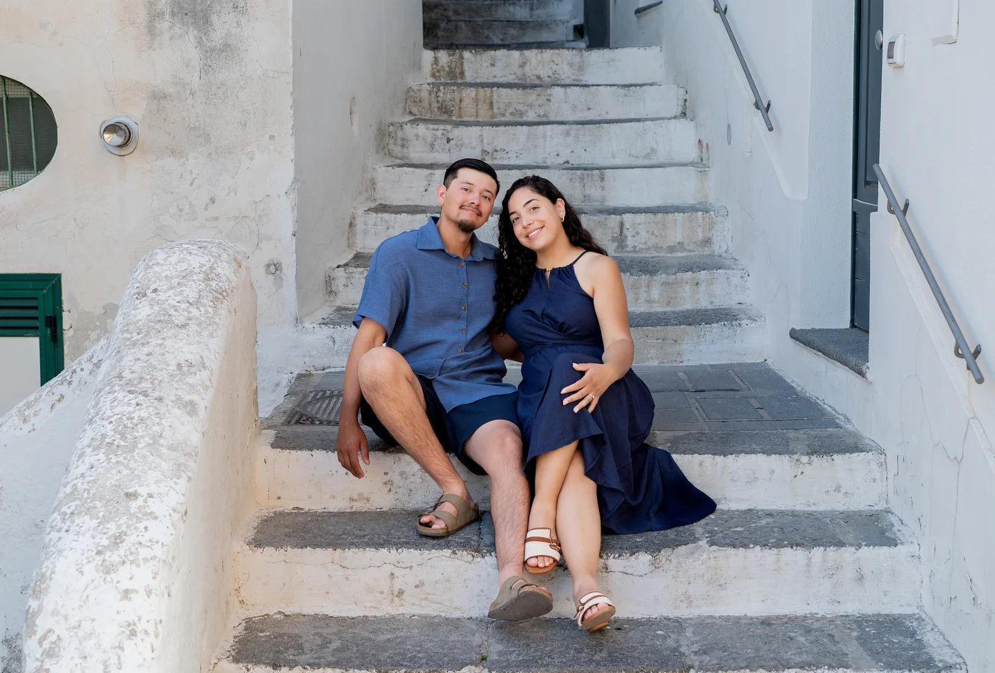 The couple leaning together on the village staircase