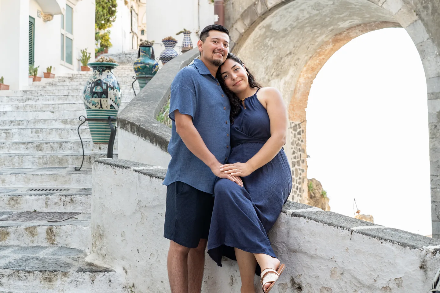 An embrace on the curving stone staircase