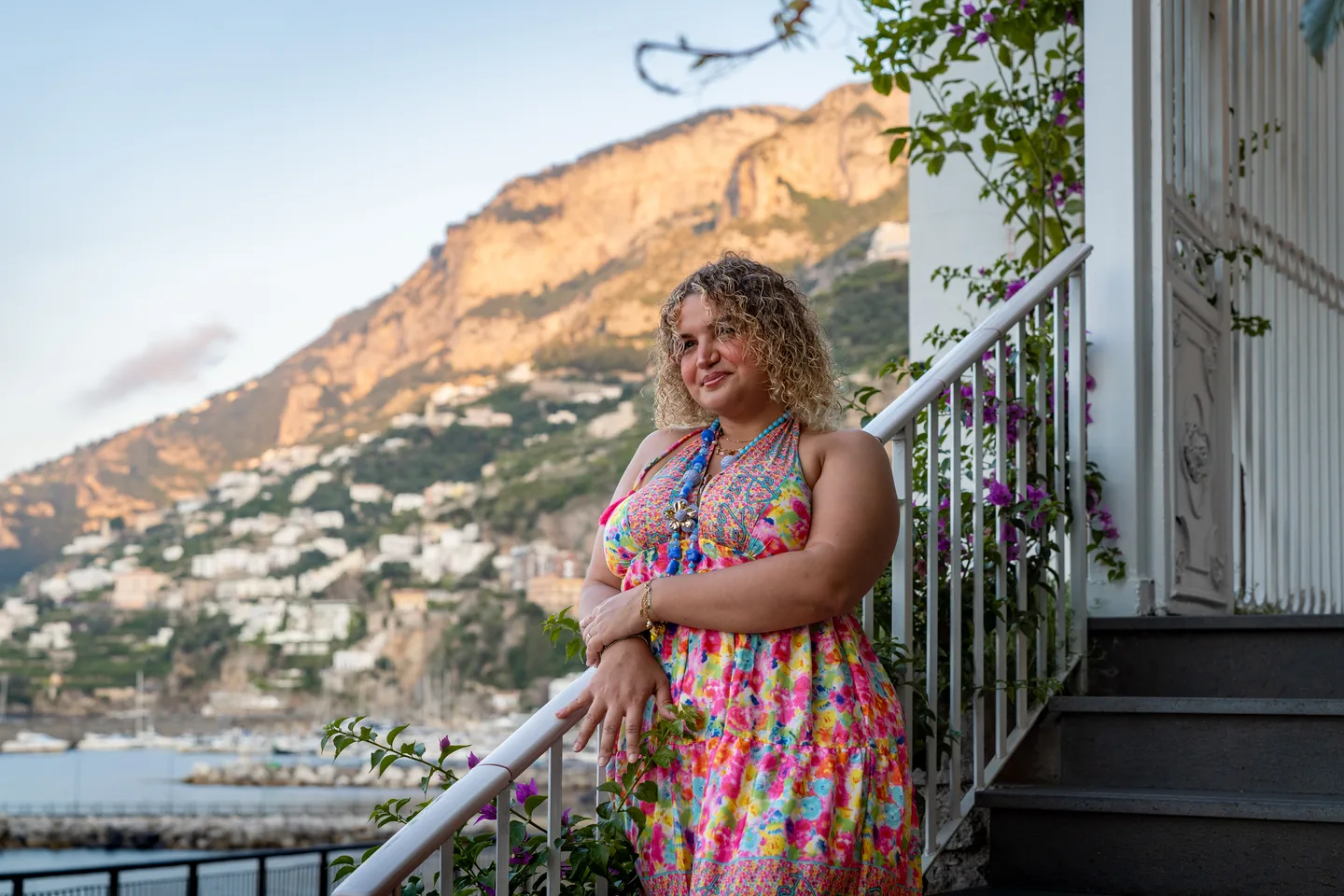 Hinad beside the waterfront railing in early light