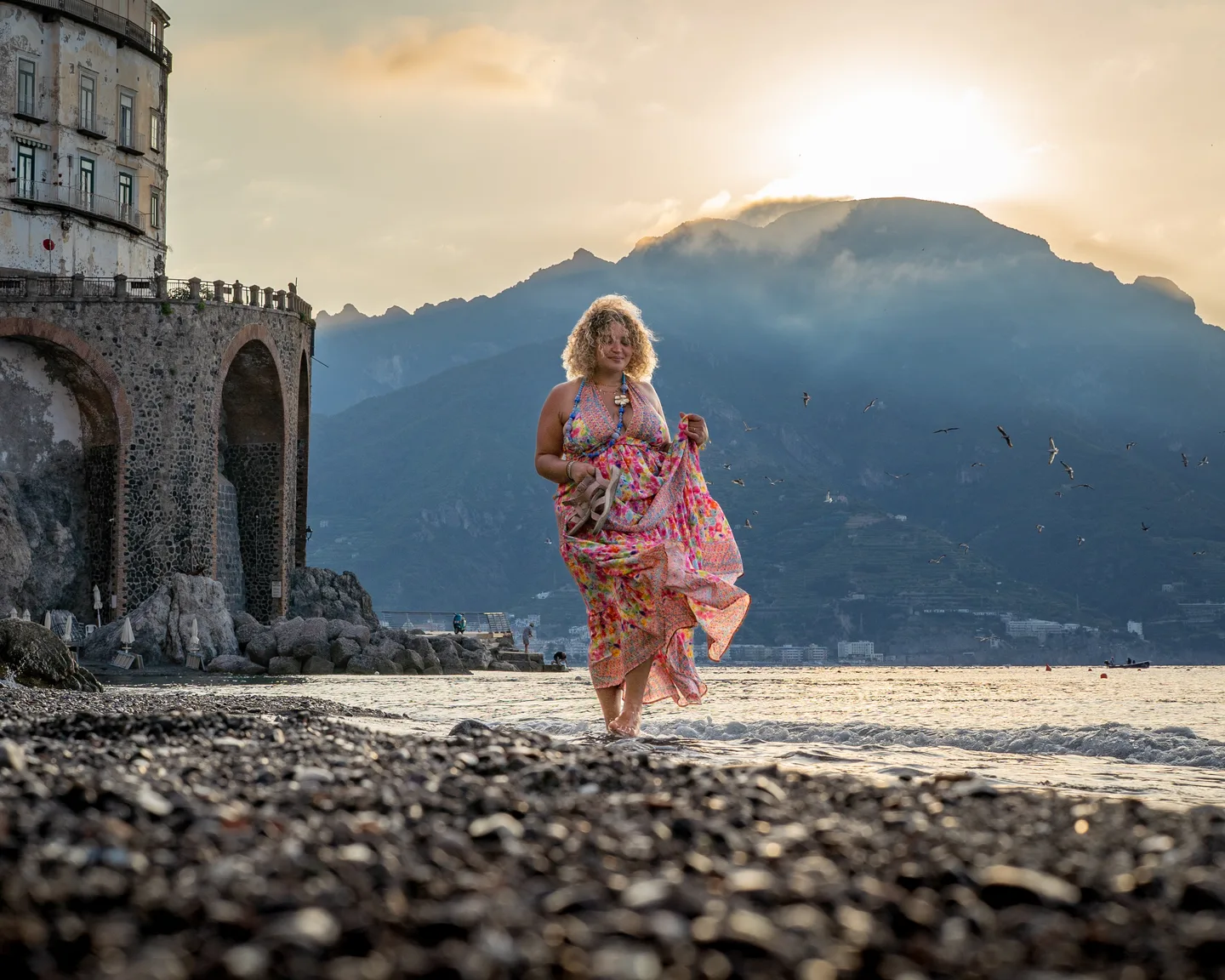 Hinad walking towards the camera across the beach