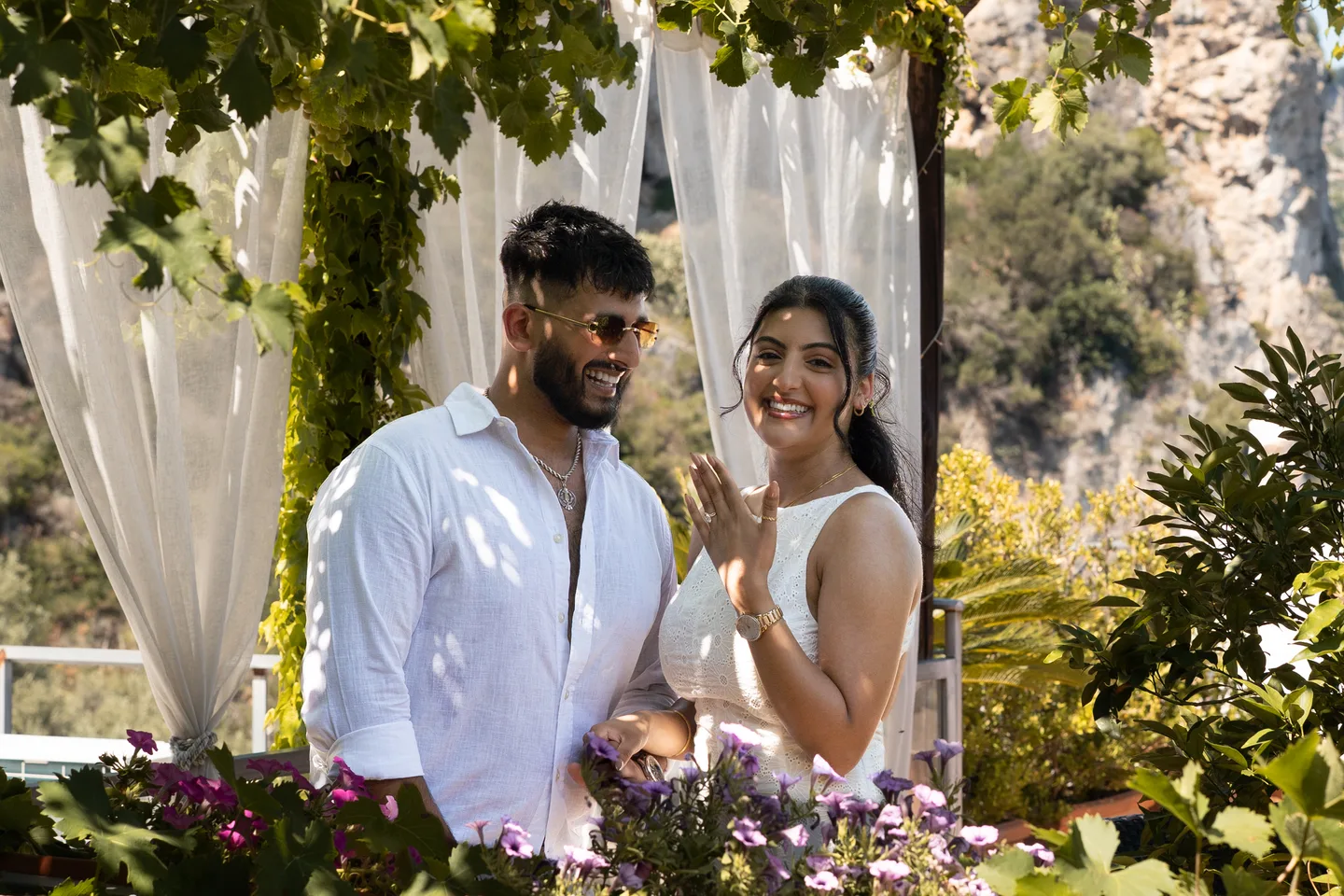 The couple beneath the villa’s leafy pergola