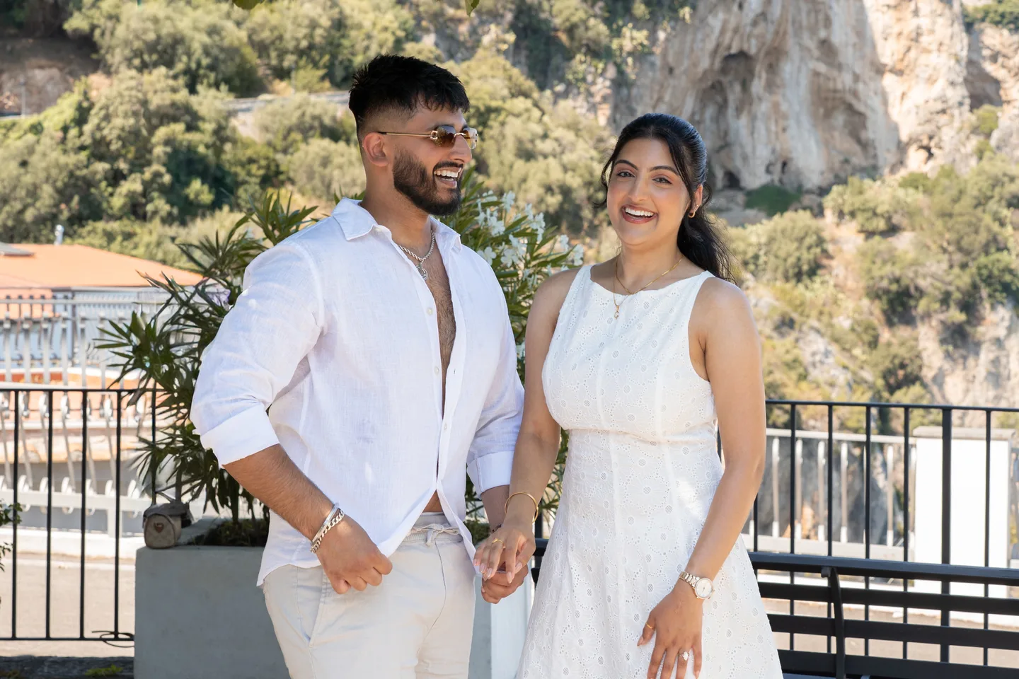 The couple smiling above the garden
