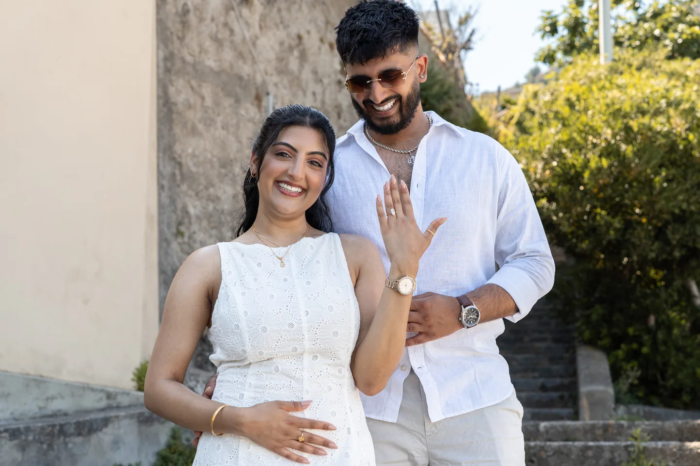 The couple showing the engagement ring