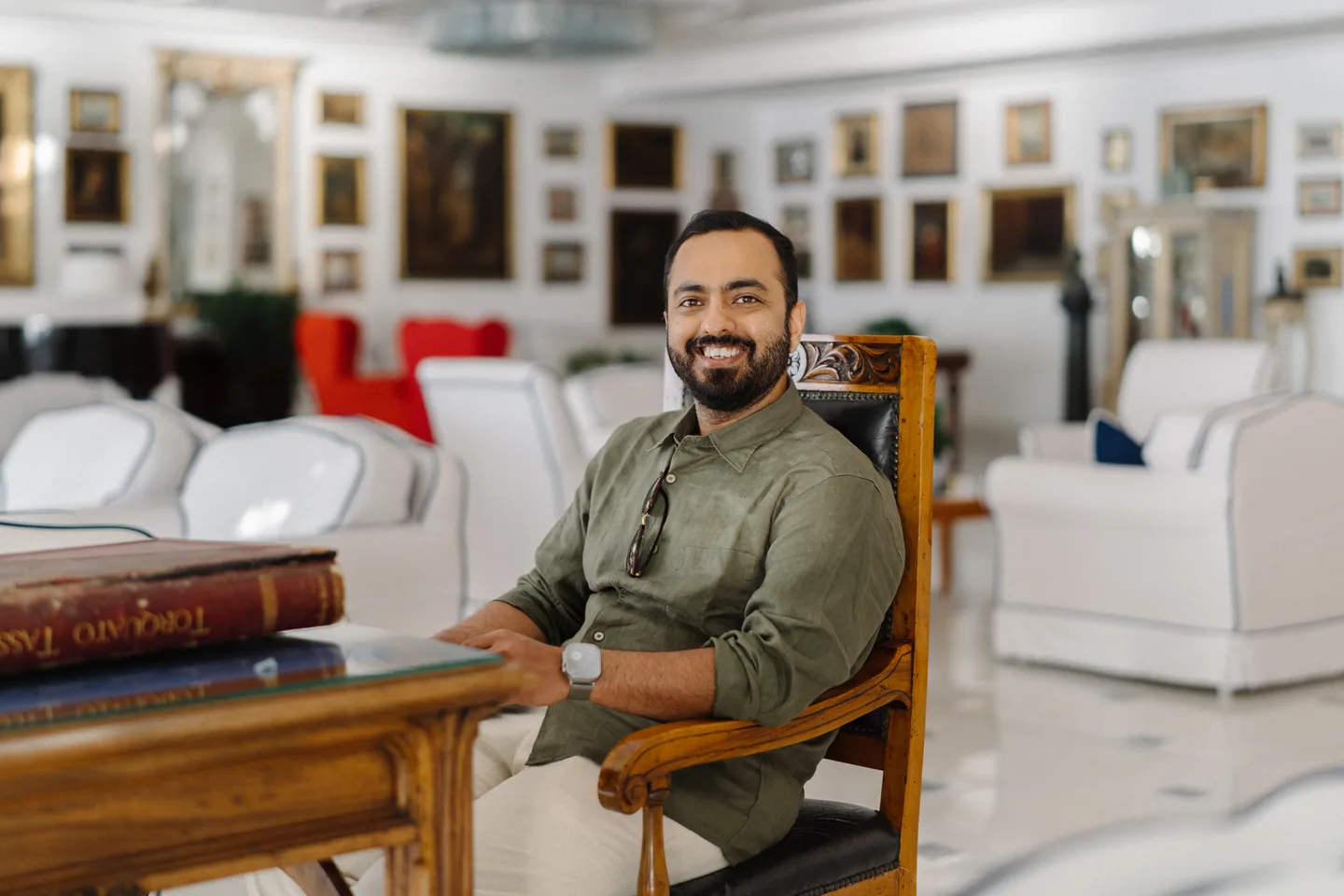 Jatin at a wooden table in the hotel