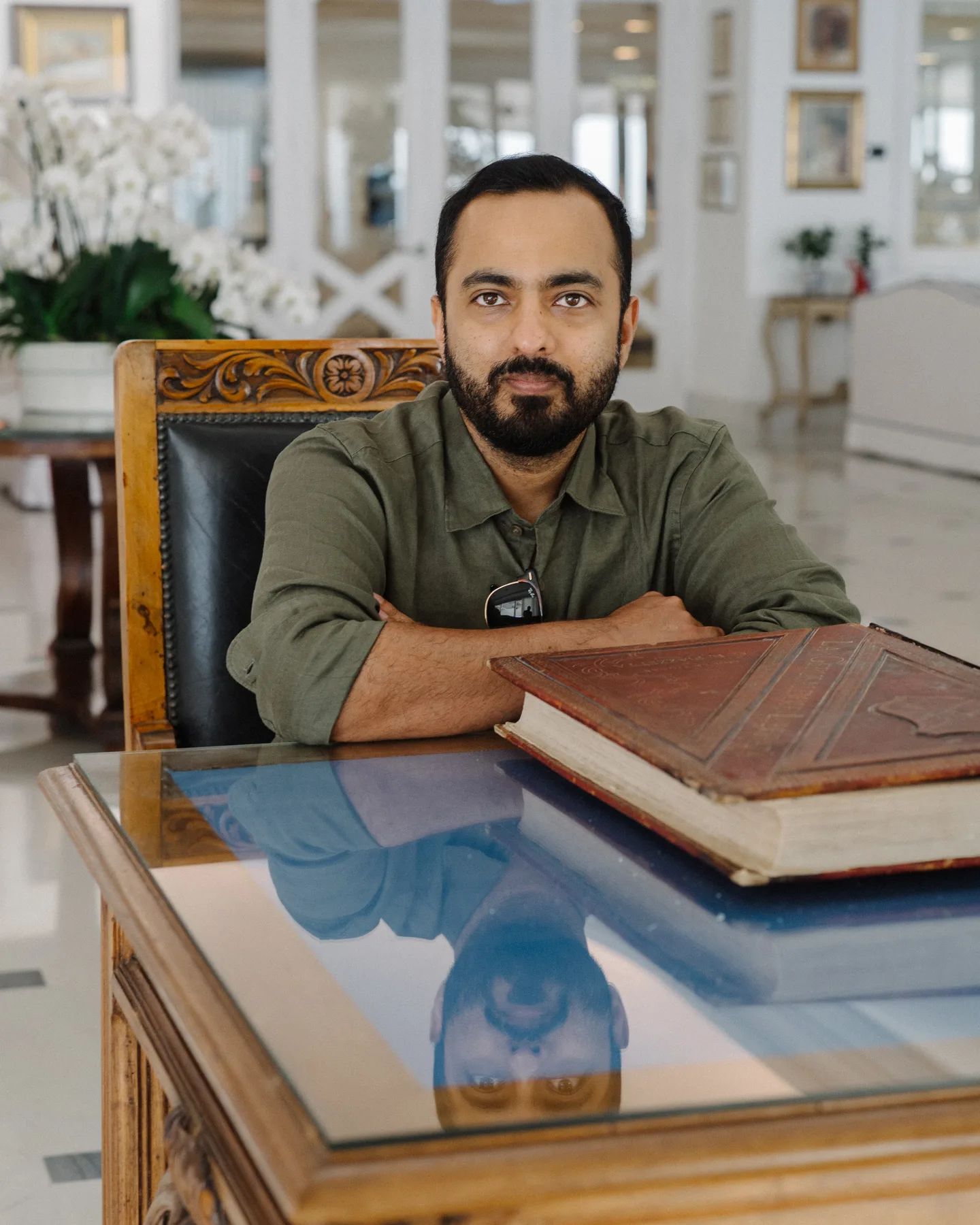 Jatin resting his arms on a table