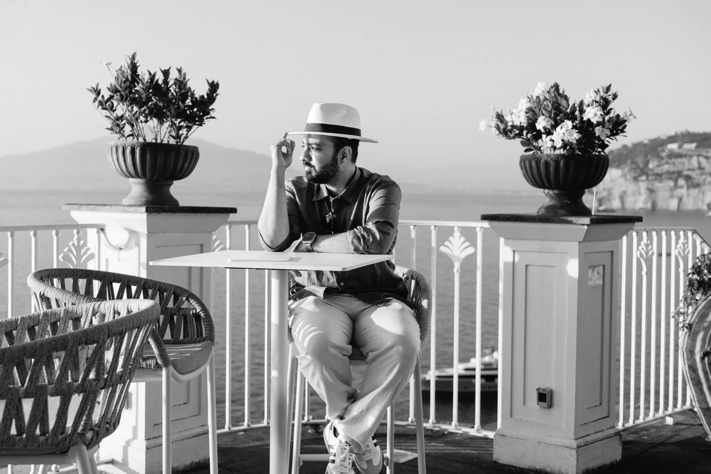 Jatin seated with his hat at the terrace table