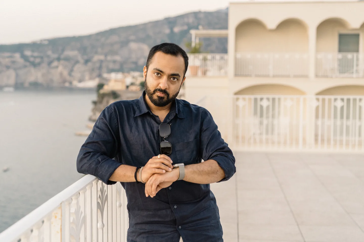 Jatin leaning on the white railing
