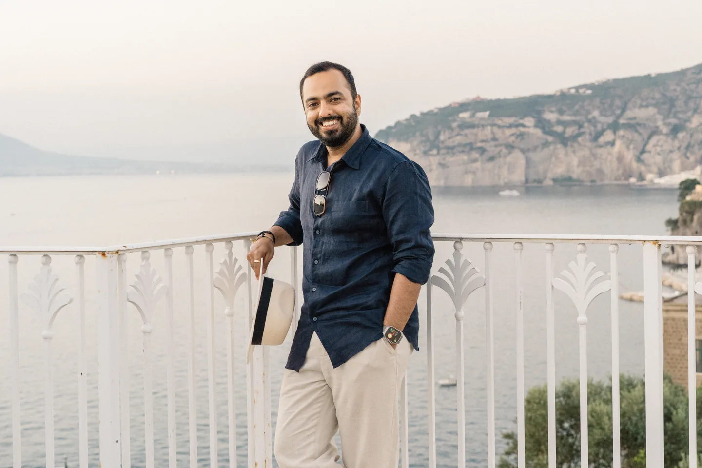 Jatin smiling on the sea-view terrace