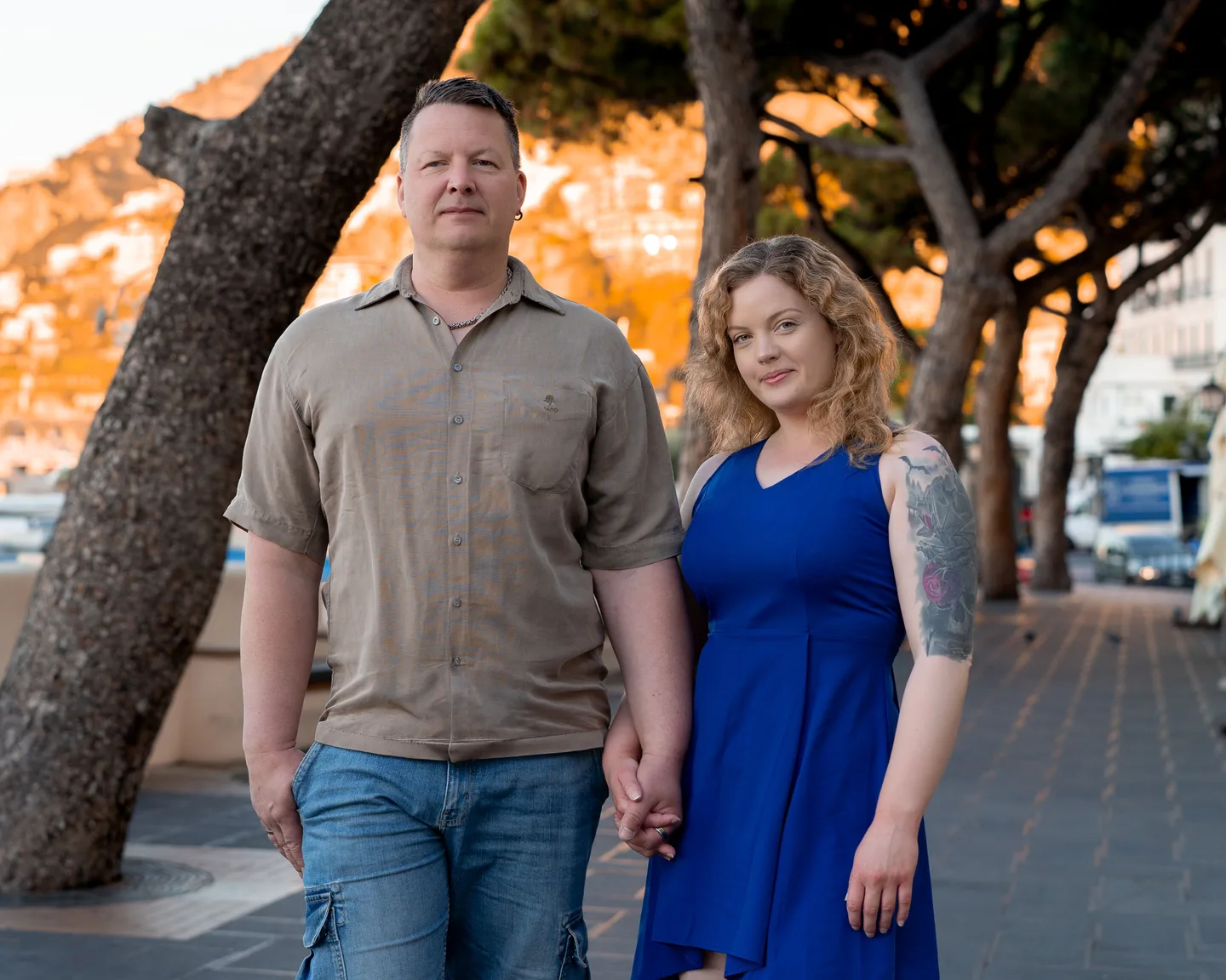 The couple together beneath the waterfront trees
