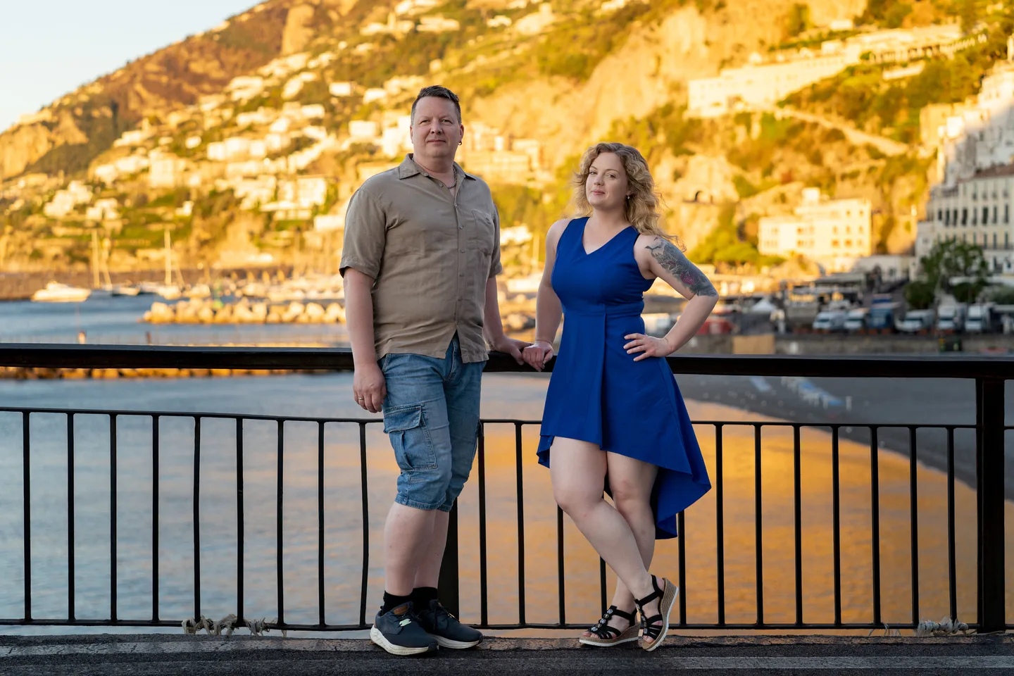 The couple beside the railing in warm morning light