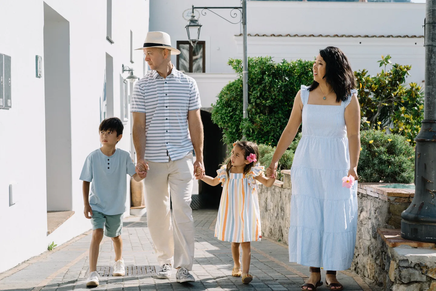 The family exploring a narrow village lane