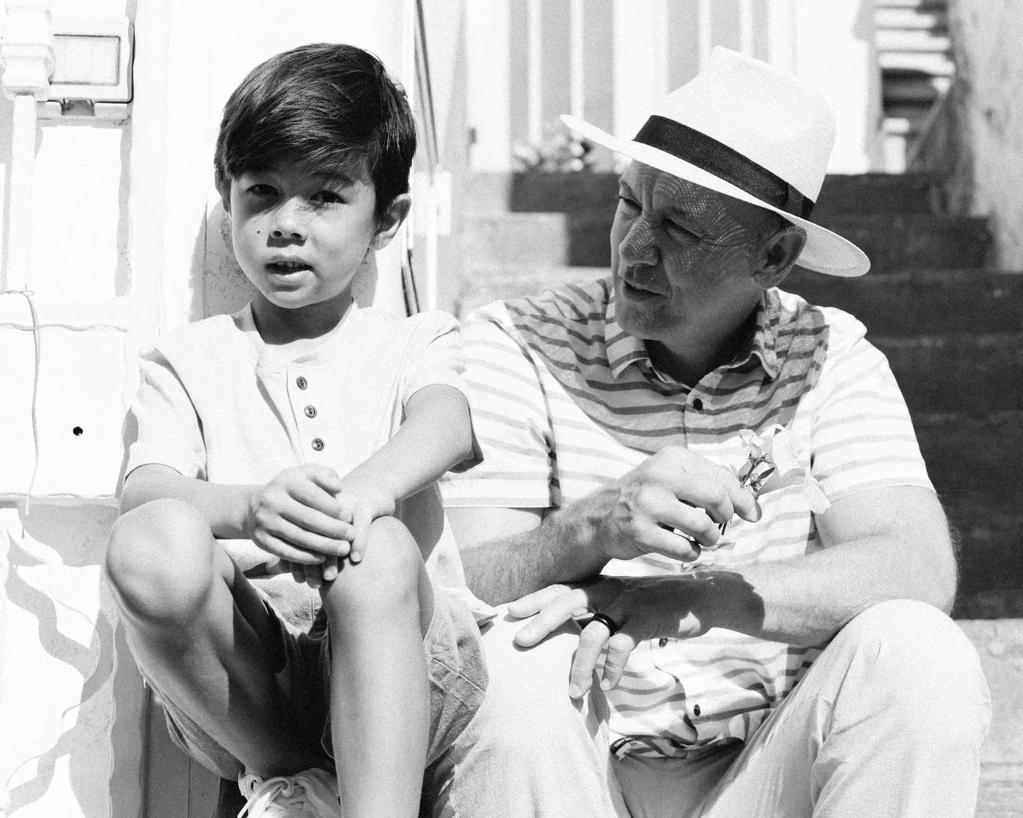 Nick and his son on the steps in black and white