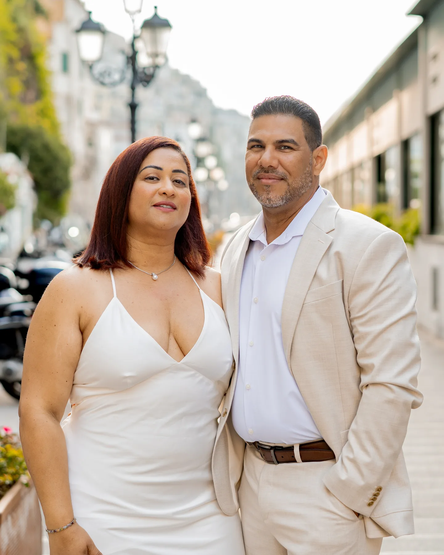A portrait of the couple beside a waterfront street lamp