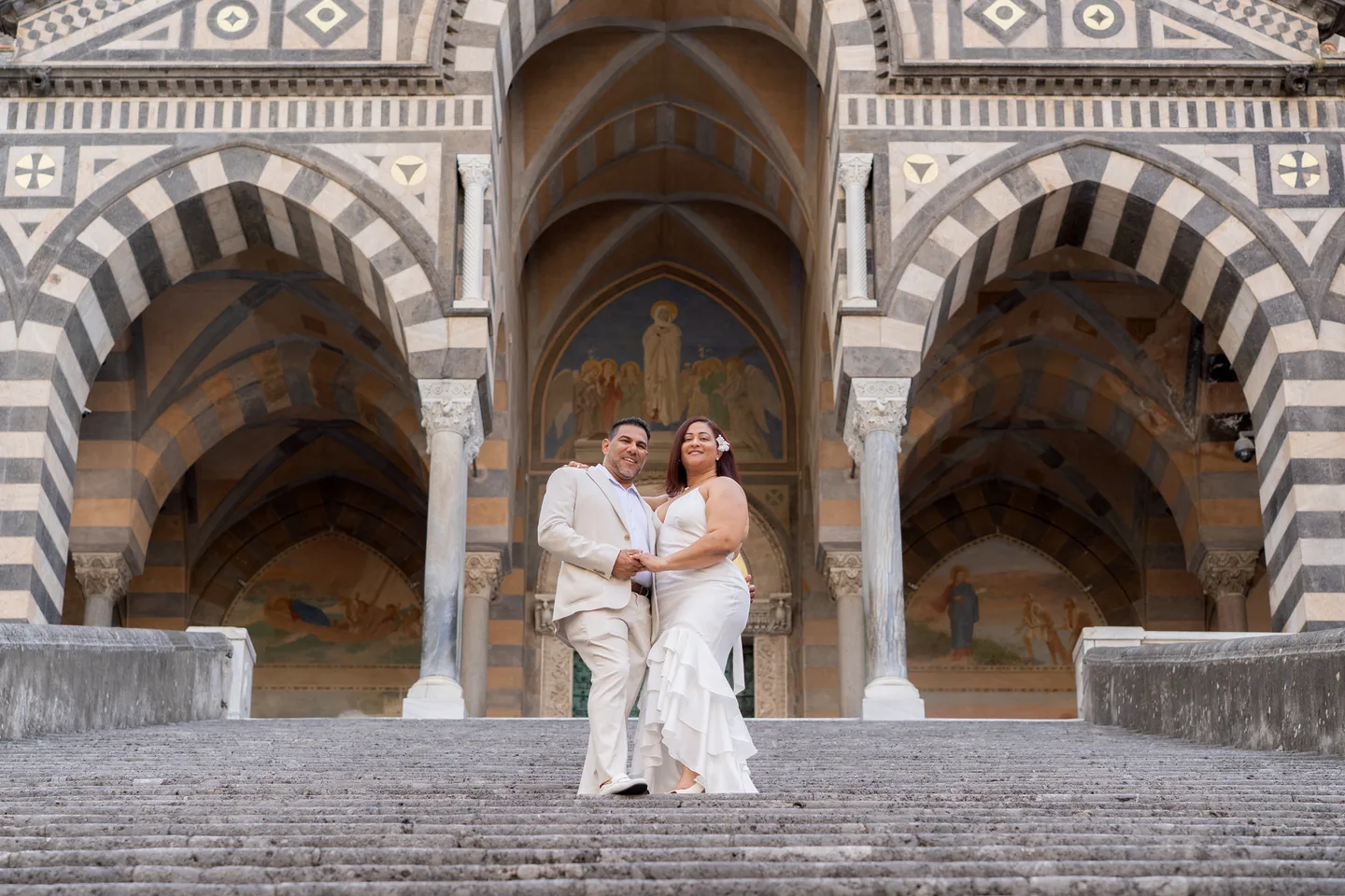 Nilsa and her husband at the top of the cathedral steps