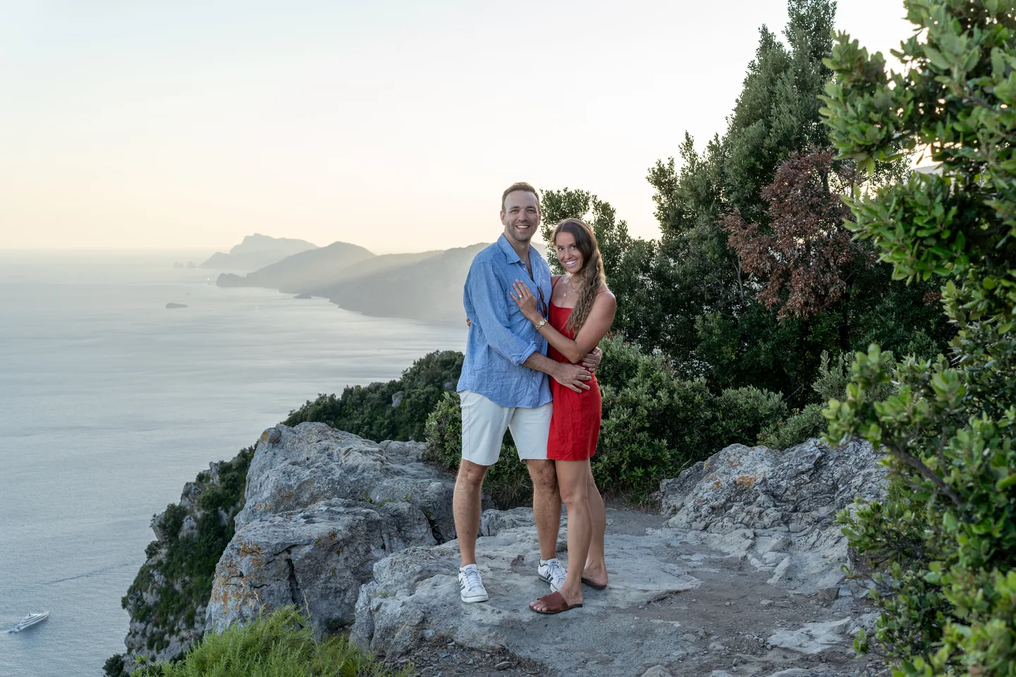 The couple in red and blue above the coastline