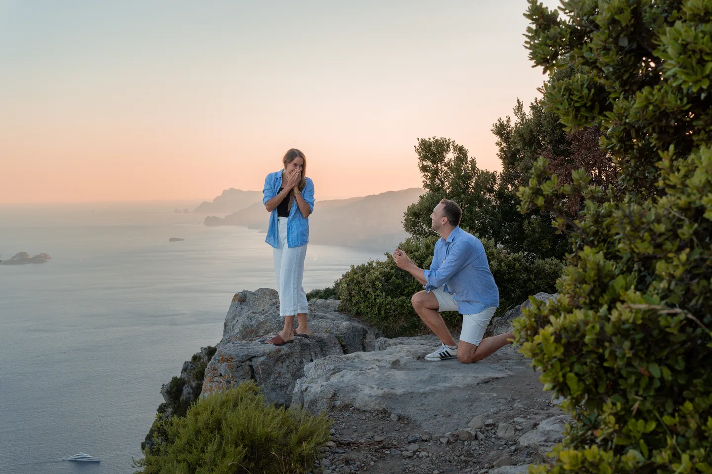 The couple laughing during their proposal portraits