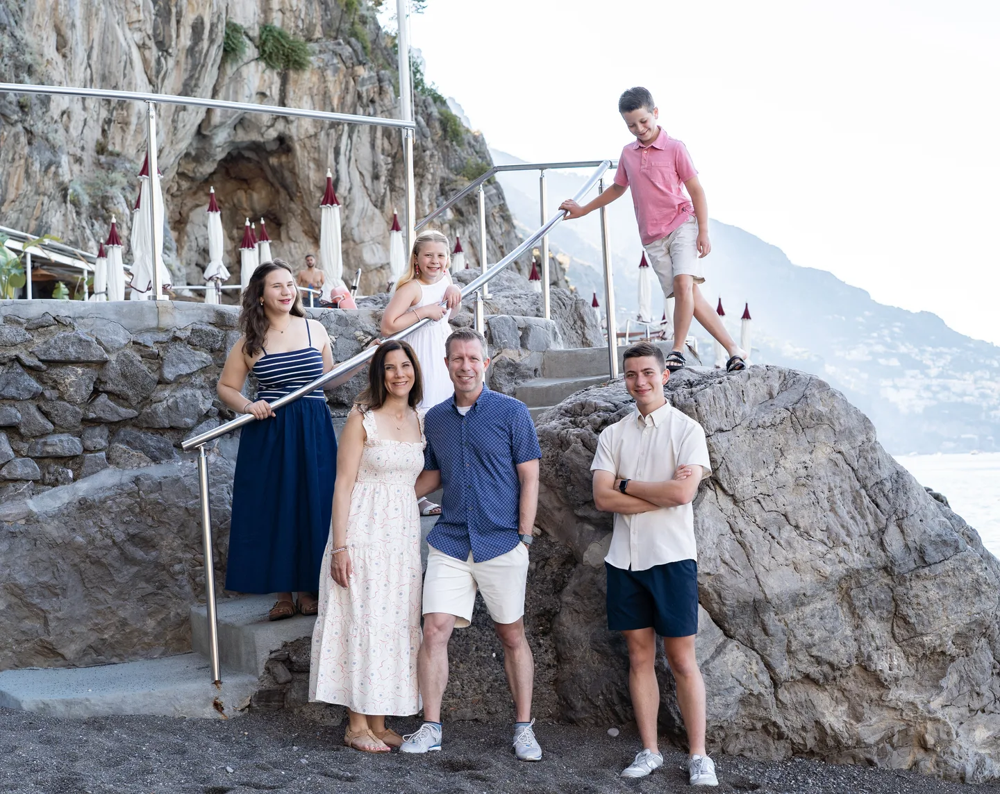 The family arranged around the beach steps