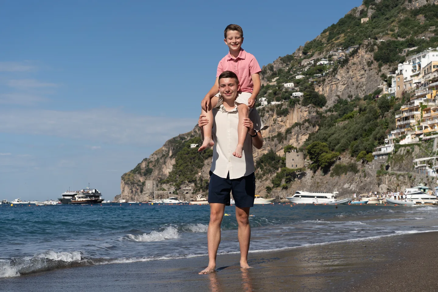 A child riding on shoulders by the sea