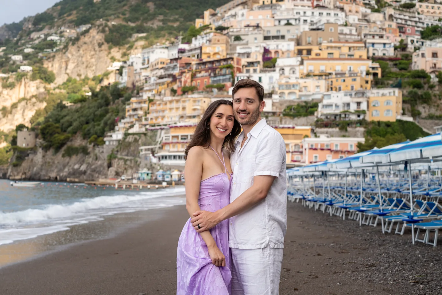 An embrace on the beach beneath Positano
