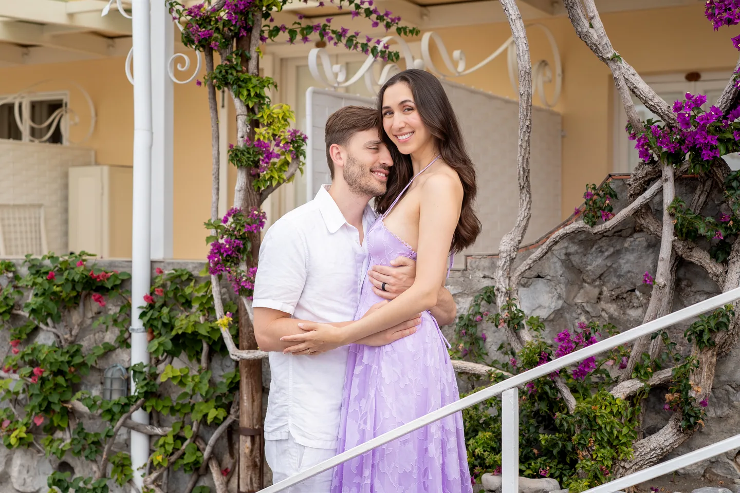 The couple laughing on the village steps