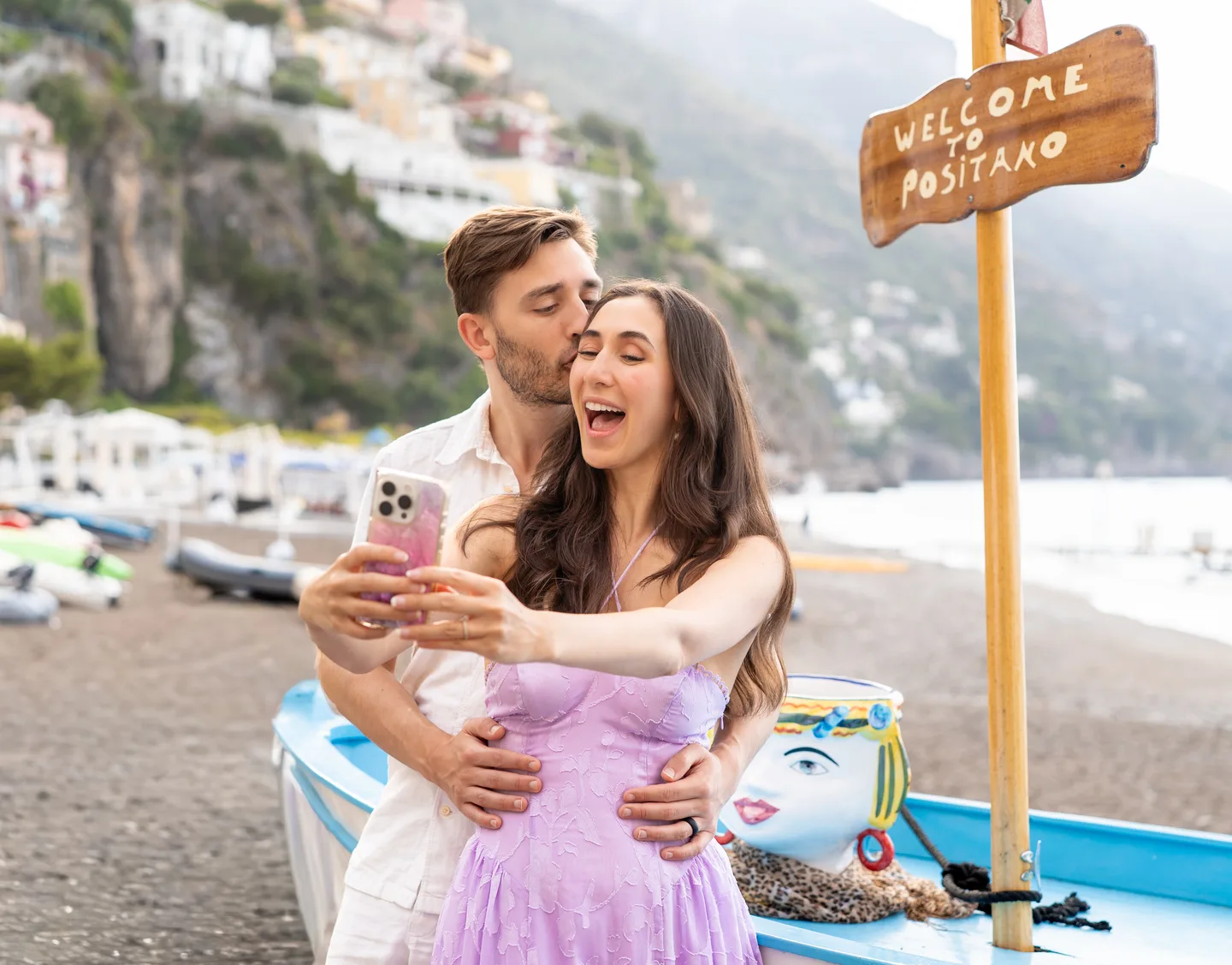 The couple laughing together beside the boat