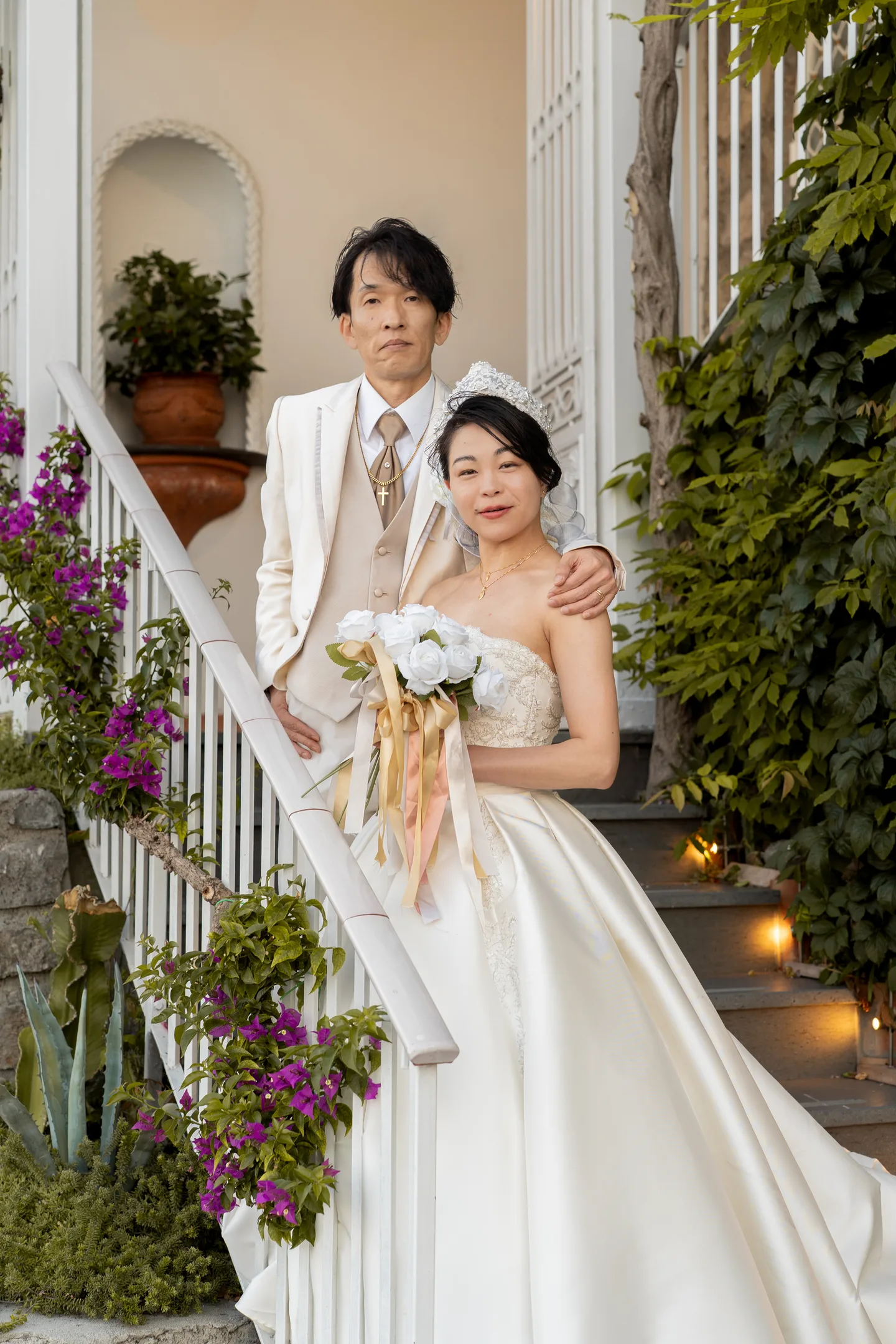 Takamasa and his partner in wedding clothes on the hotel steps