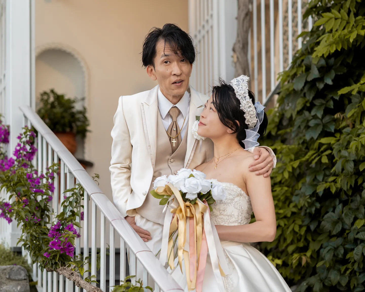 The couple together beside the hotel’s flowering plants