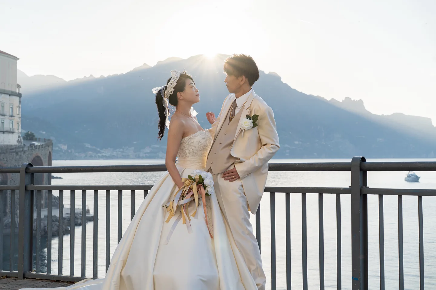 The couple framed by the mountain skyline at sunrise