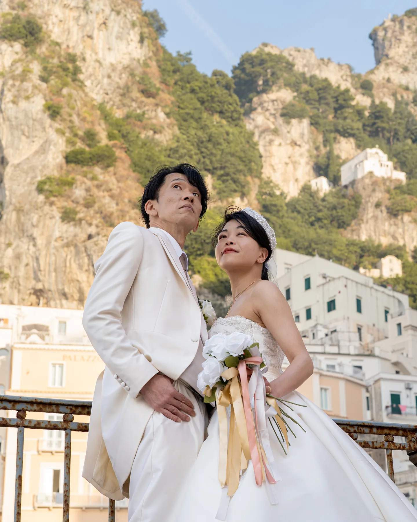 A portrait of the couple beneath Atrani’s hillside houses