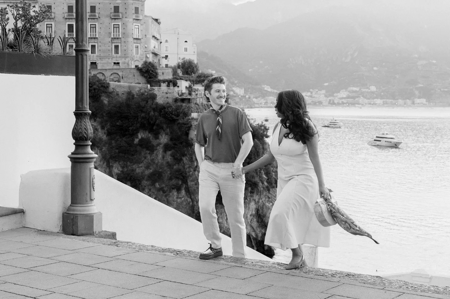 The couple walking above the sea in black and white