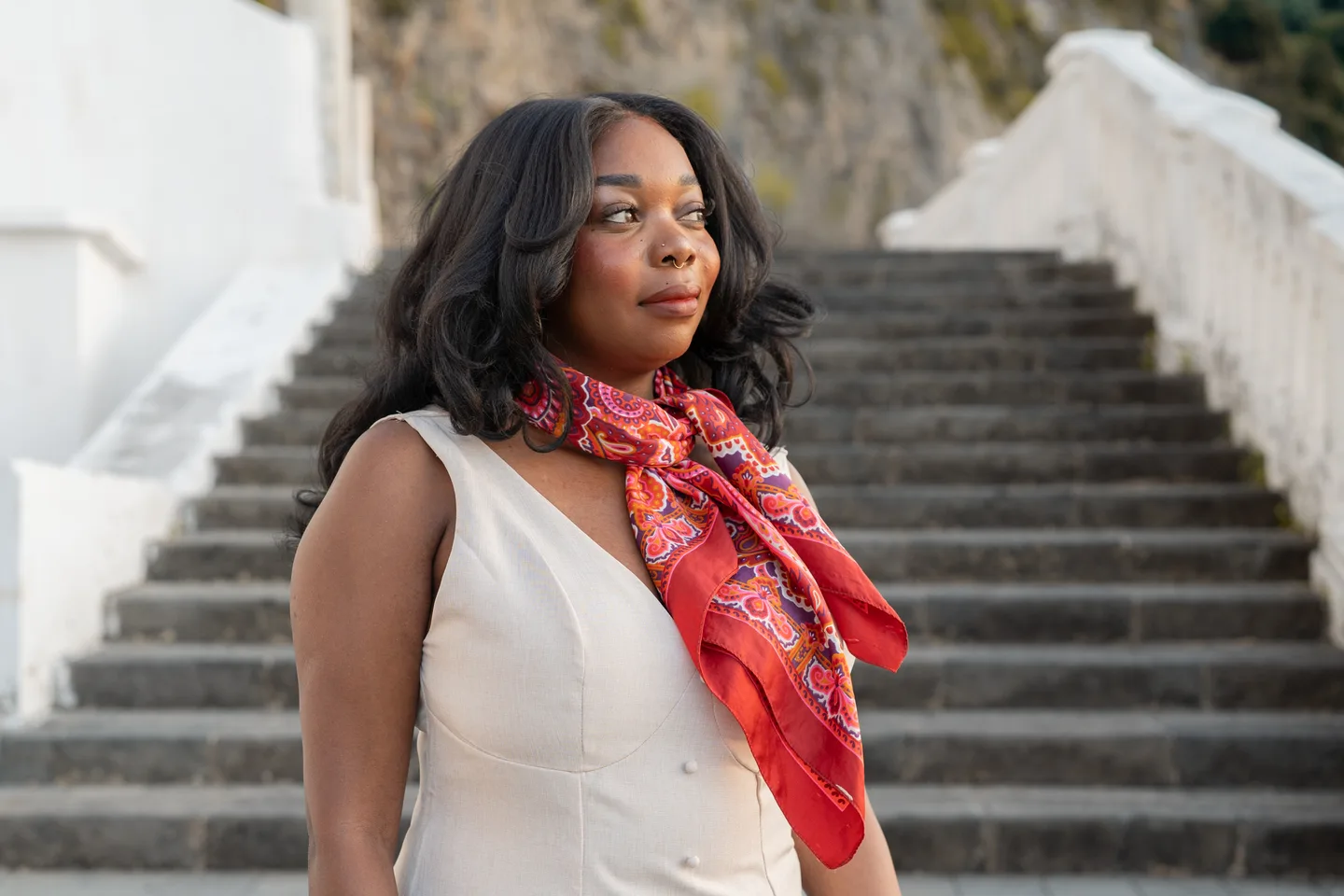 Sam in a red scarf beside the white steps