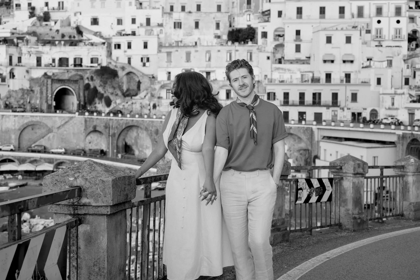 The couple beside the village railing in black and white
