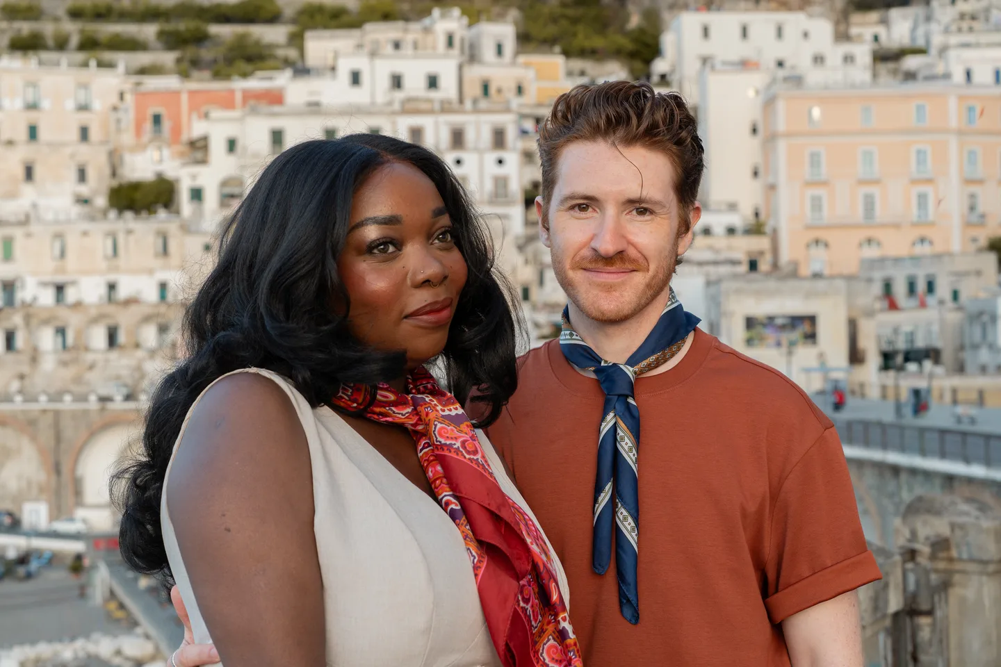 A close portrait of the couple with Atrani behind them